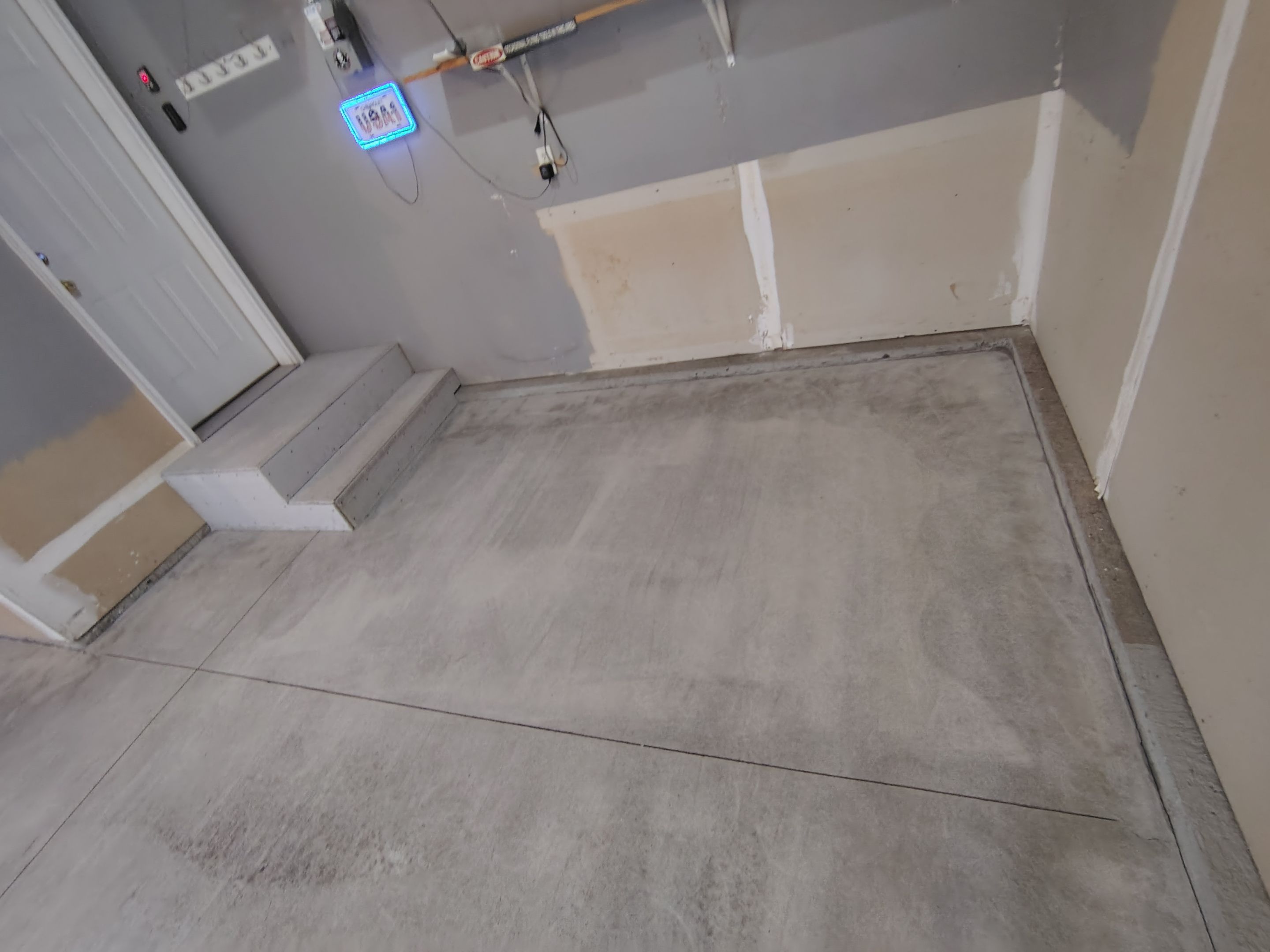 Nightfall Grey Speckled Epoxy Garage Floor Coating in Sioux Falls by Select Painting, Coatings & Garage Cabinets