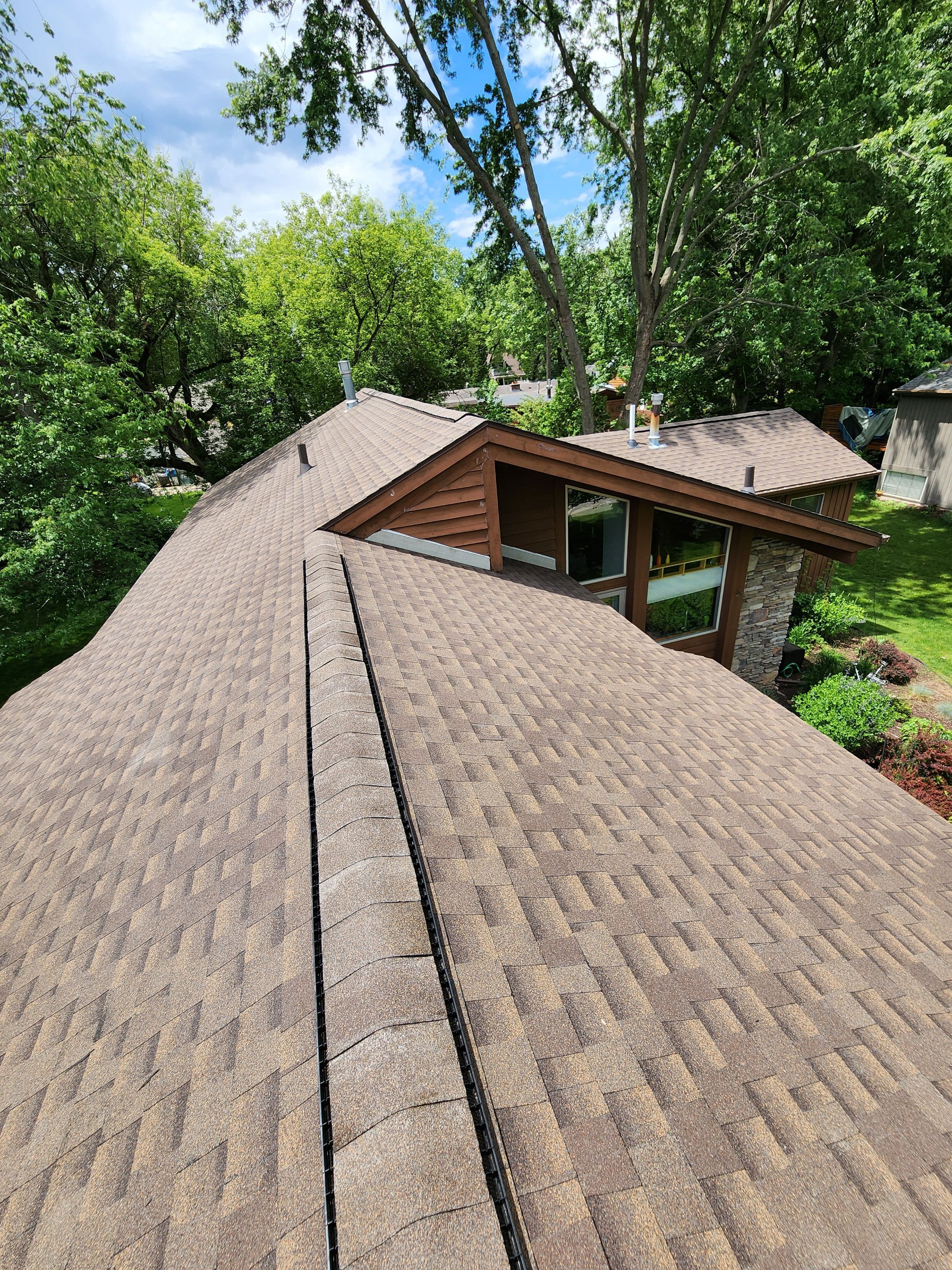 Installing new Roof and Gutter Protection after Hail Damage by Acme Exteriors