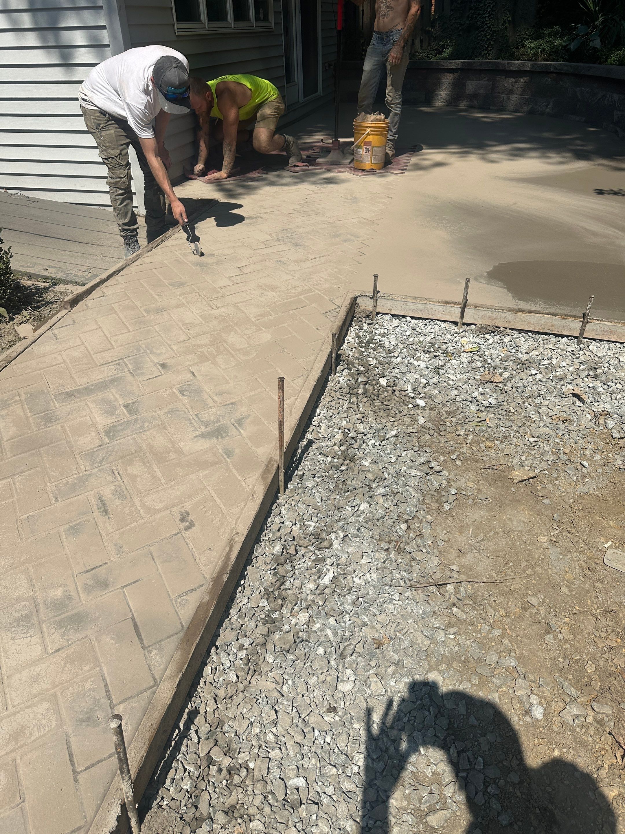 Stamped Concrete and Retaining Wall by Cousins Roofing Siding & Decks