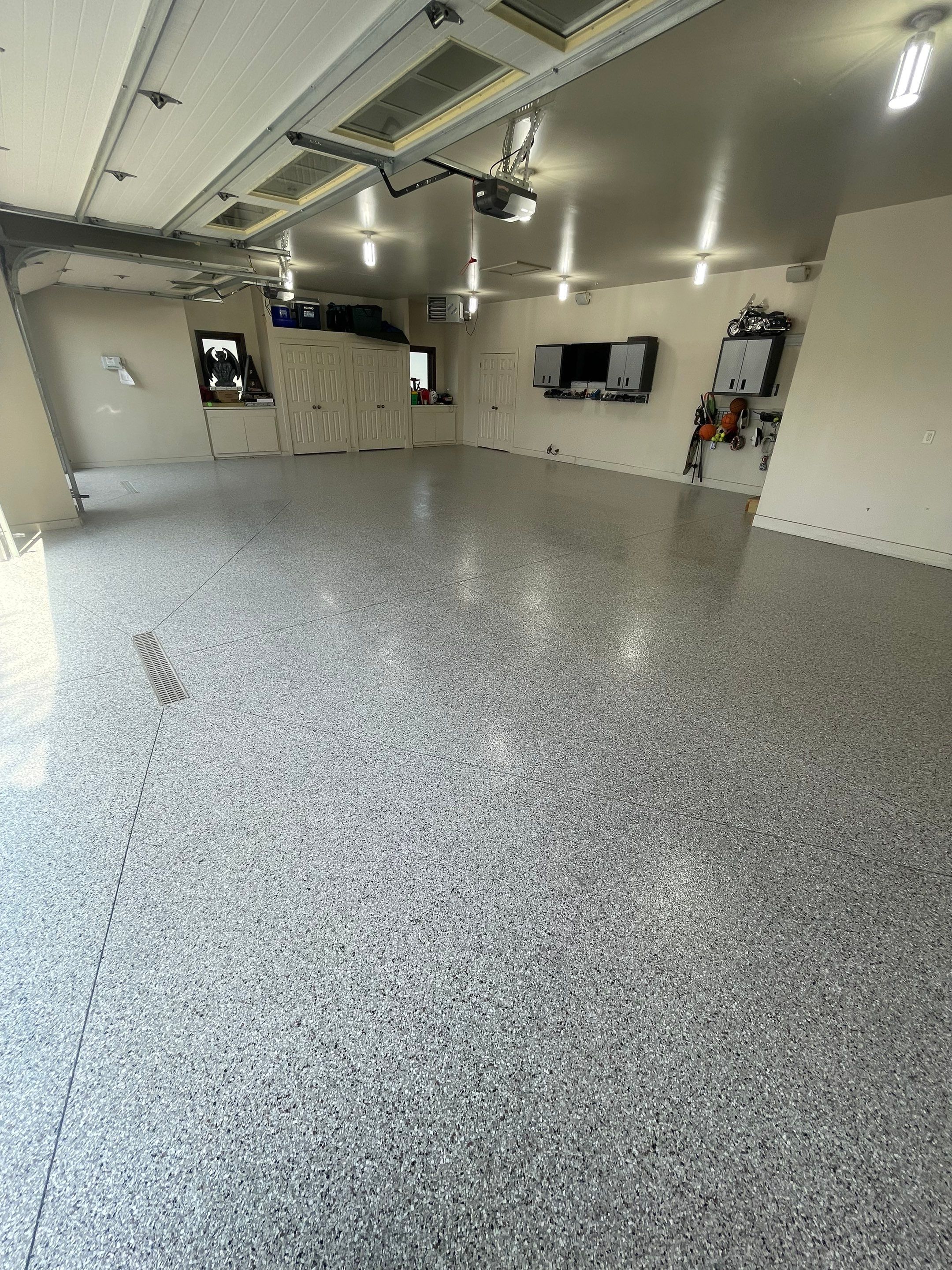 Coyote Flake Garage Floor Coating in Sioux Falls with Trench Drain by Select Painting, Coatings & Garage Cabinets