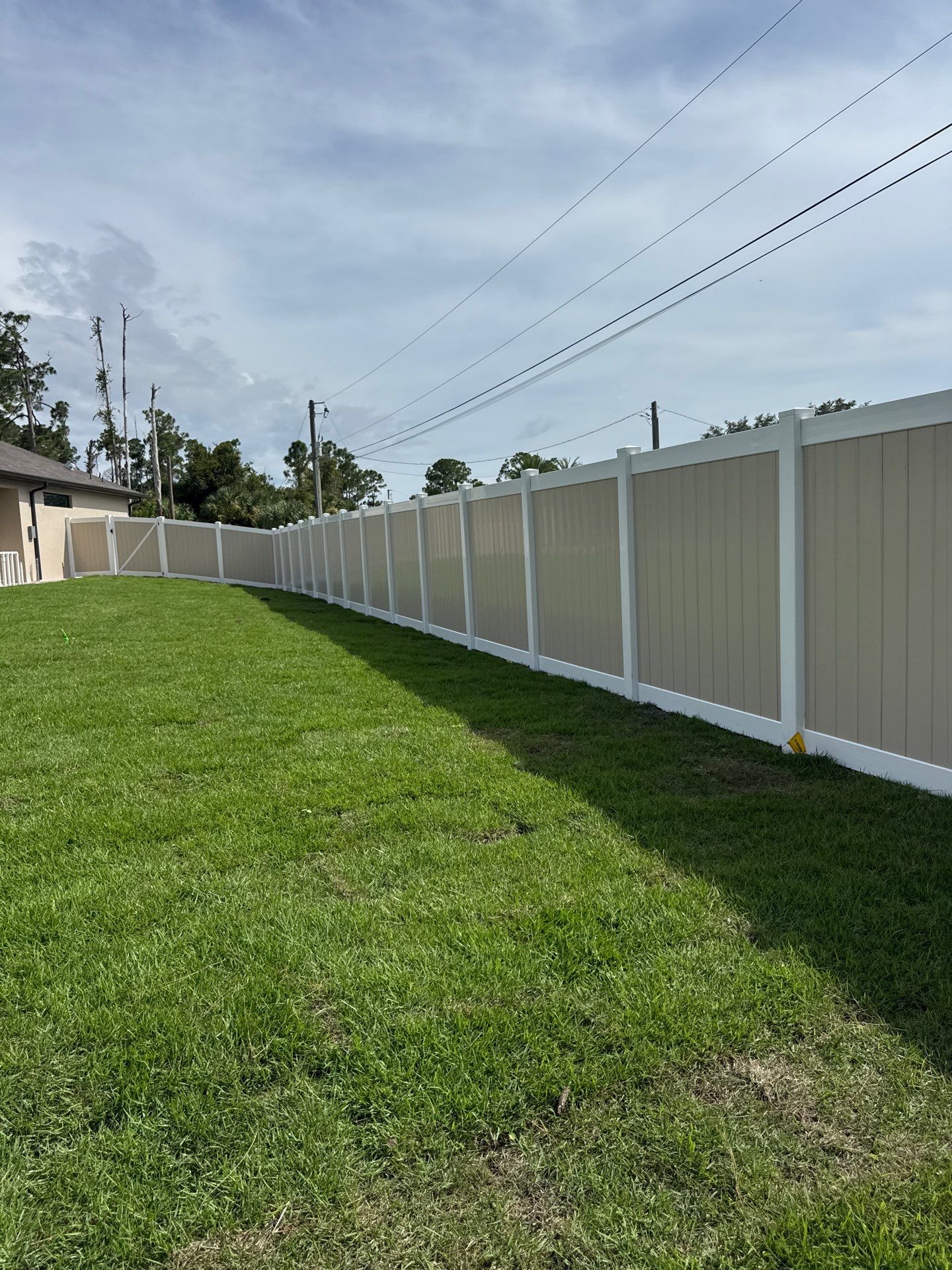 Custom Two-Tone Vinyl Privacy Fence Installation in North Port by True Fence LLC