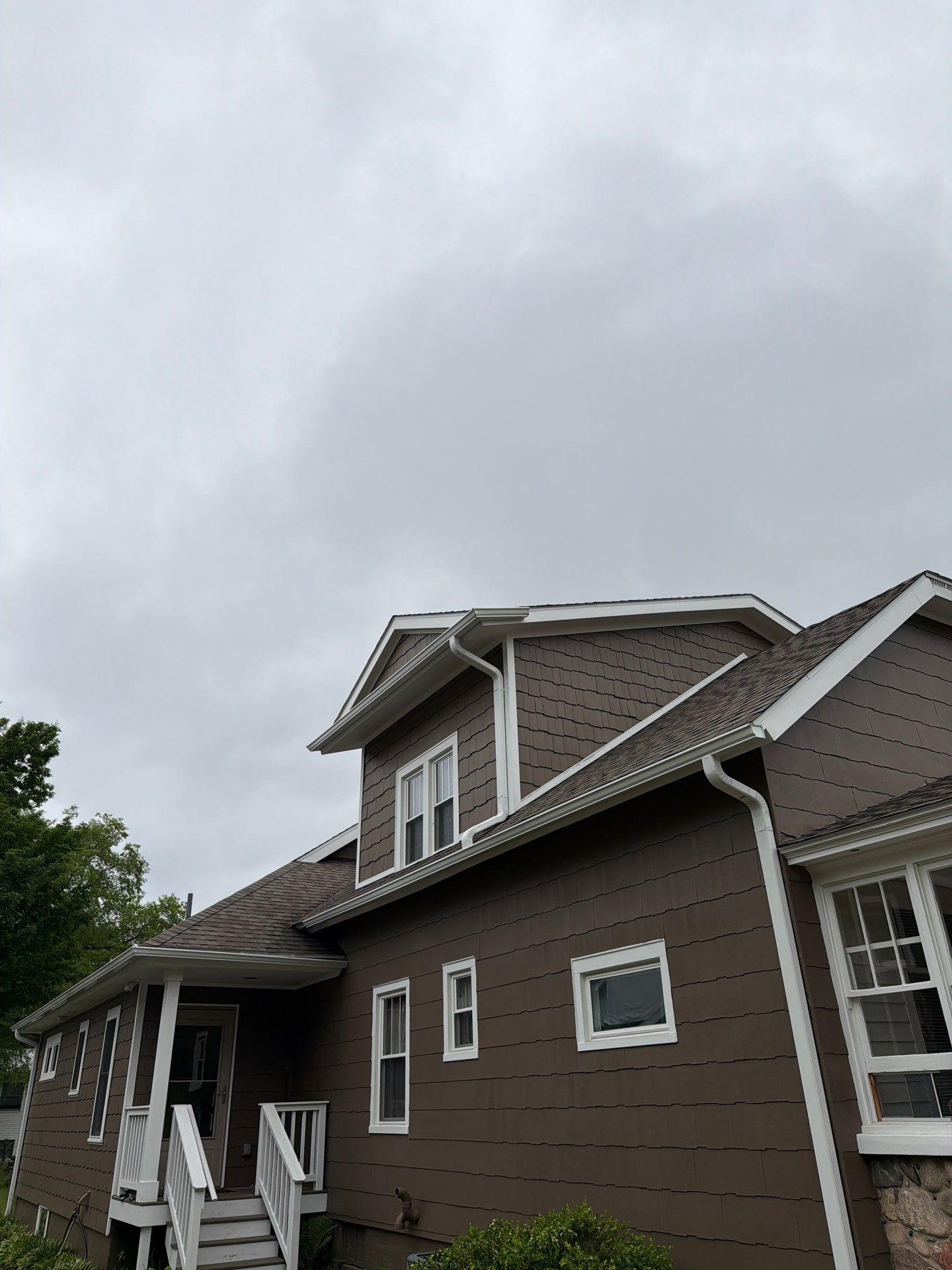 White Gutter and Downspout Installation in Boyne City by Rainbow Seamless Systems