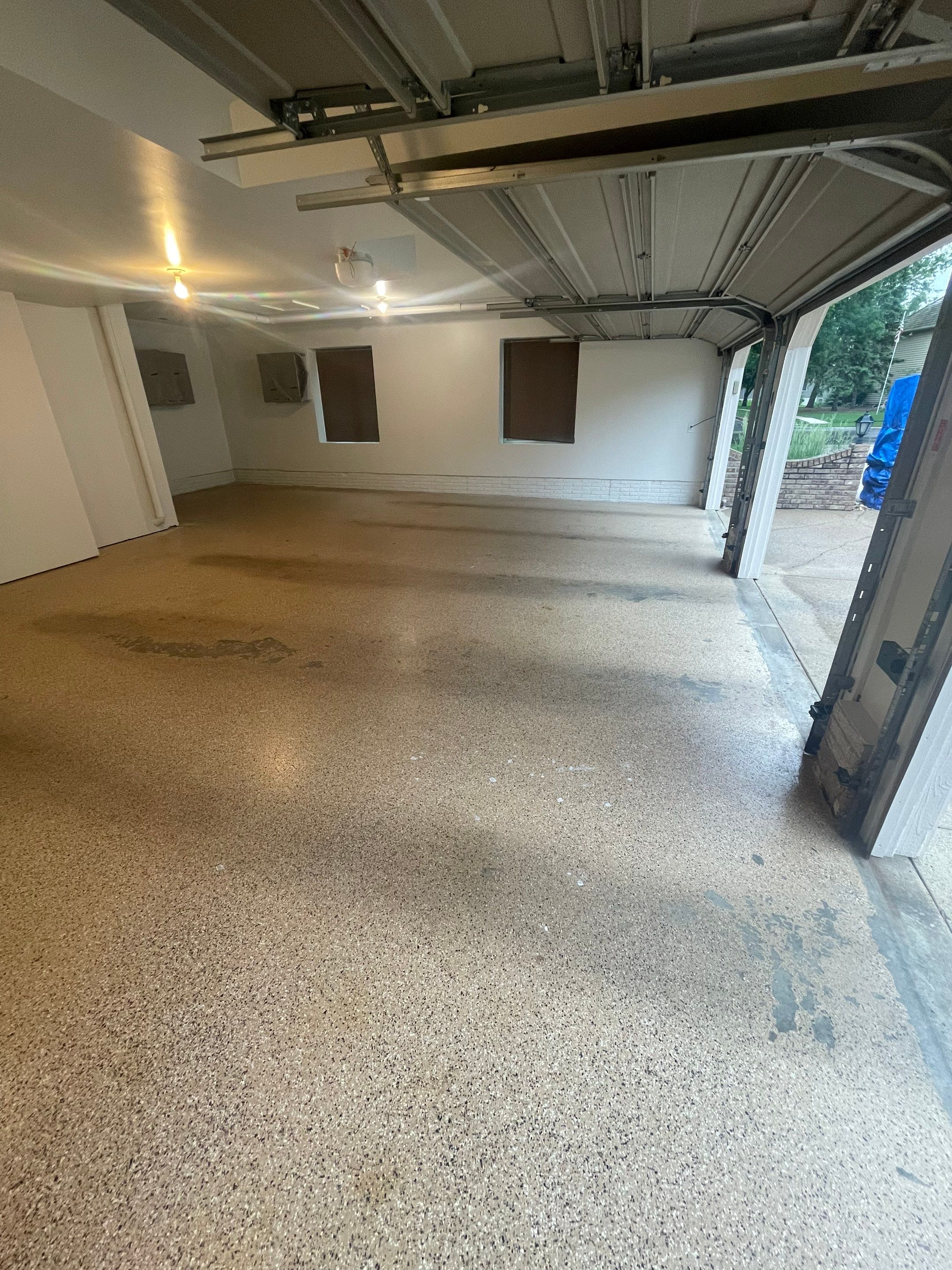 Gray Speckled Epoxy Garage Floor Coating in Sioux Falls by Select Painting, Coatings & Garage Cabinets