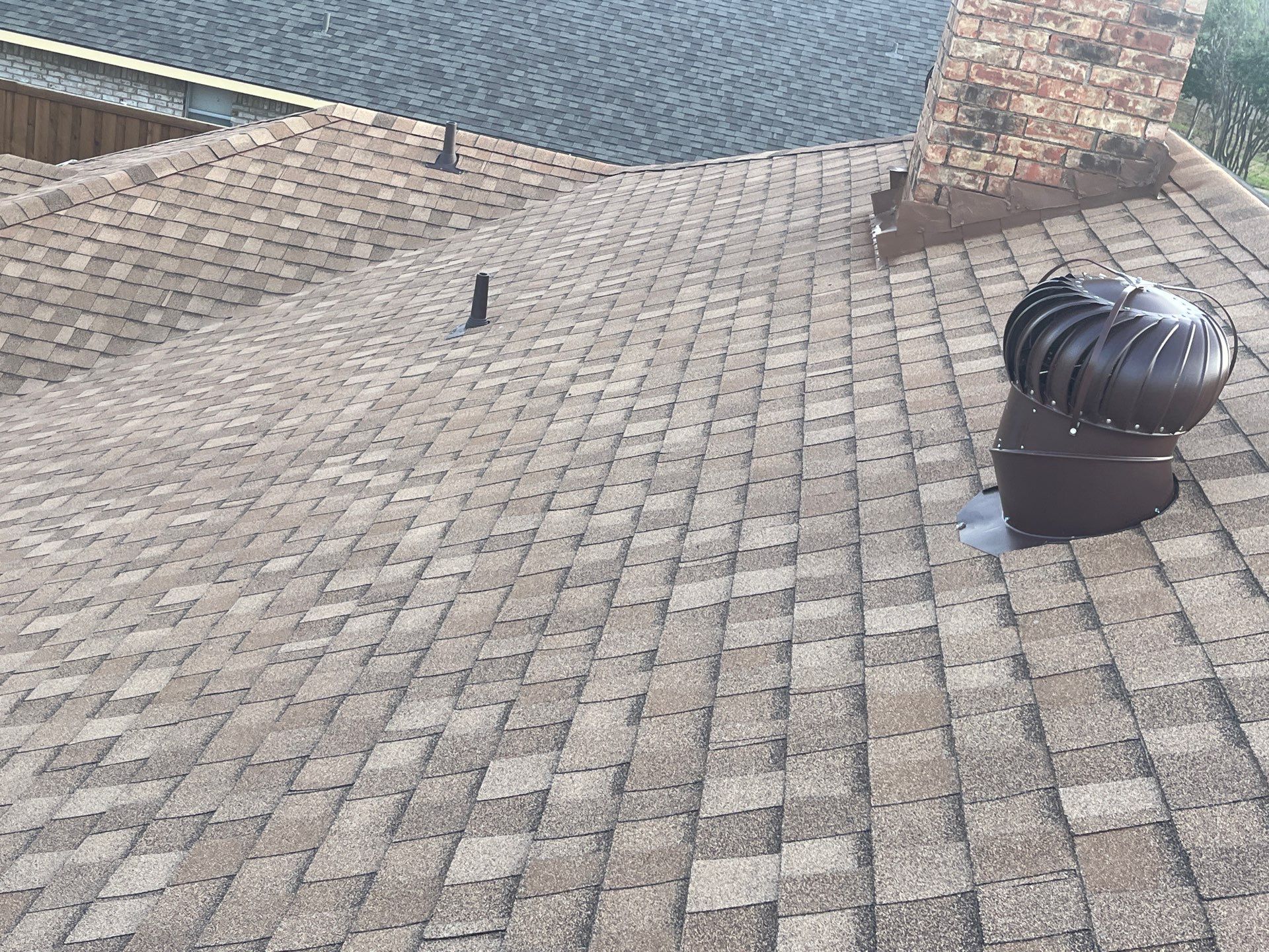 Medium brown brick with Tamko Rustic Cedar by Tejas Roofworks + Restoration
