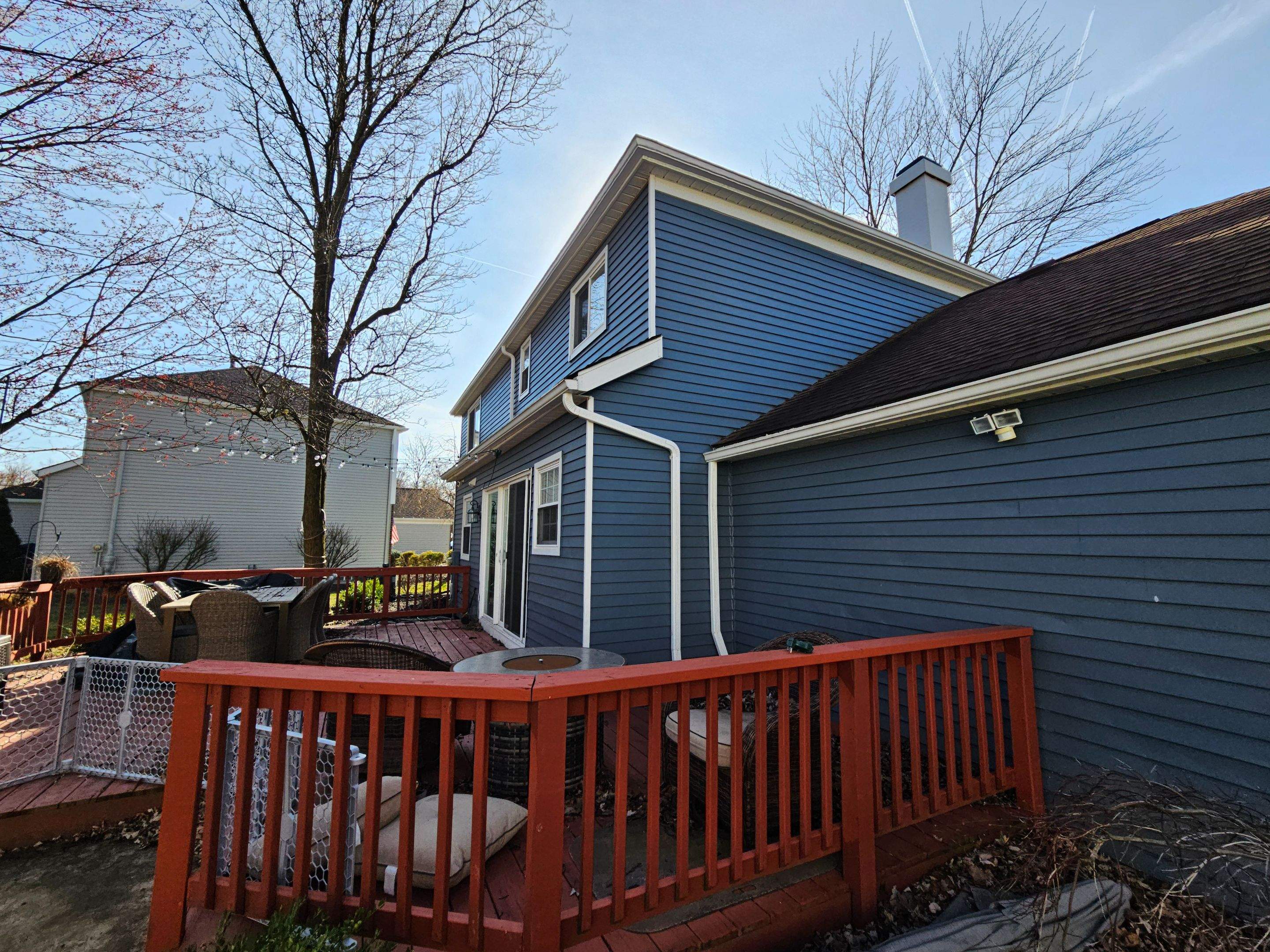 Vinyl Siding w. Stone Facade by Absolute Roofing and Construction