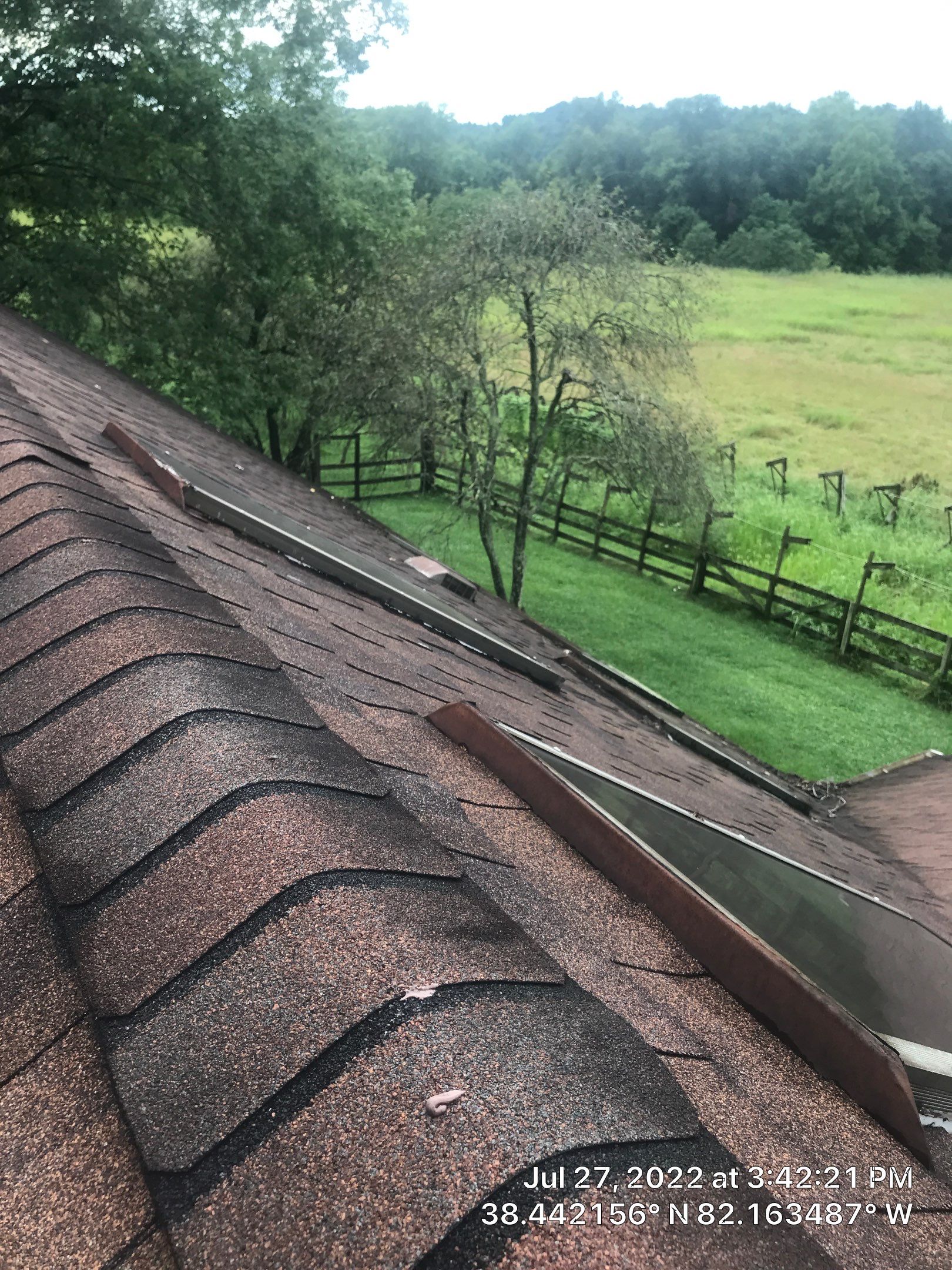 Shingle Roofing with Velux Skylight replacement and stone chimney flashing  by Secure Construction Company Inc