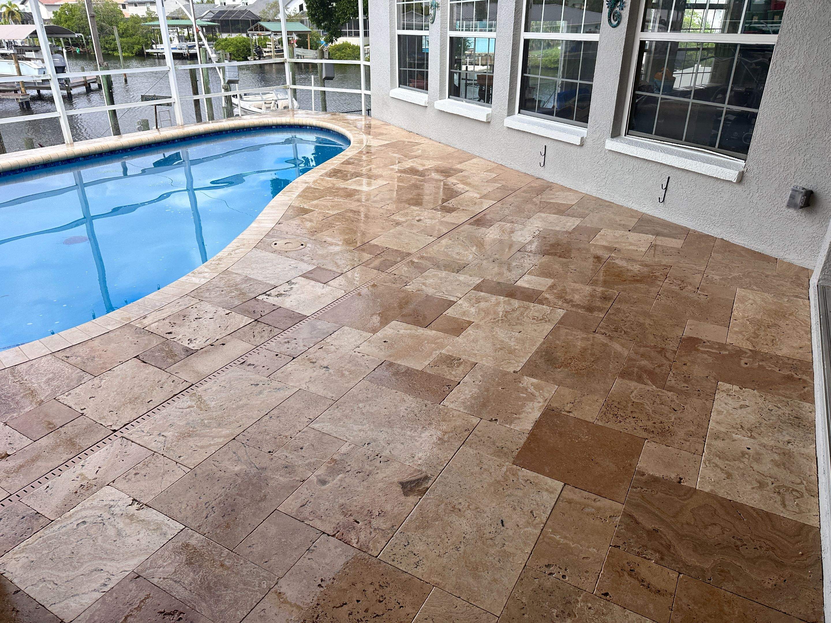 Travertine Sealing and Stripping for a Waterfront Pool Deck in Apollo Beach by Supreme Paver Experts