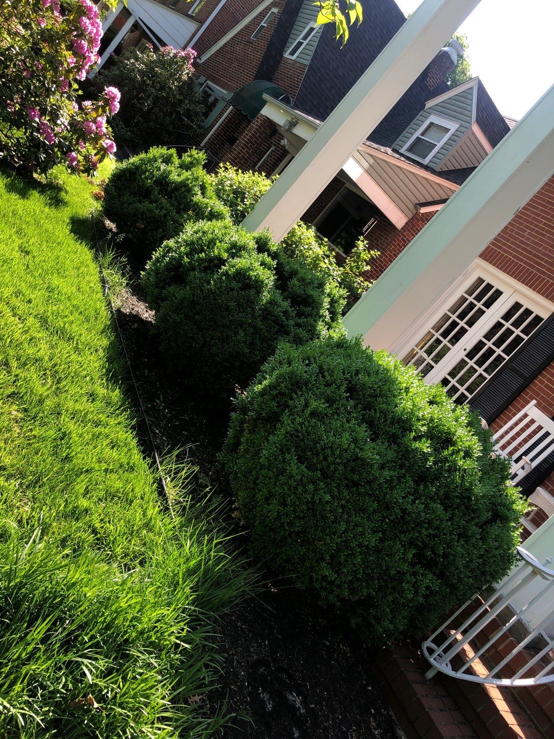 Liriope grasses, mulch and stone pavers by GrassBusters, Inc.
