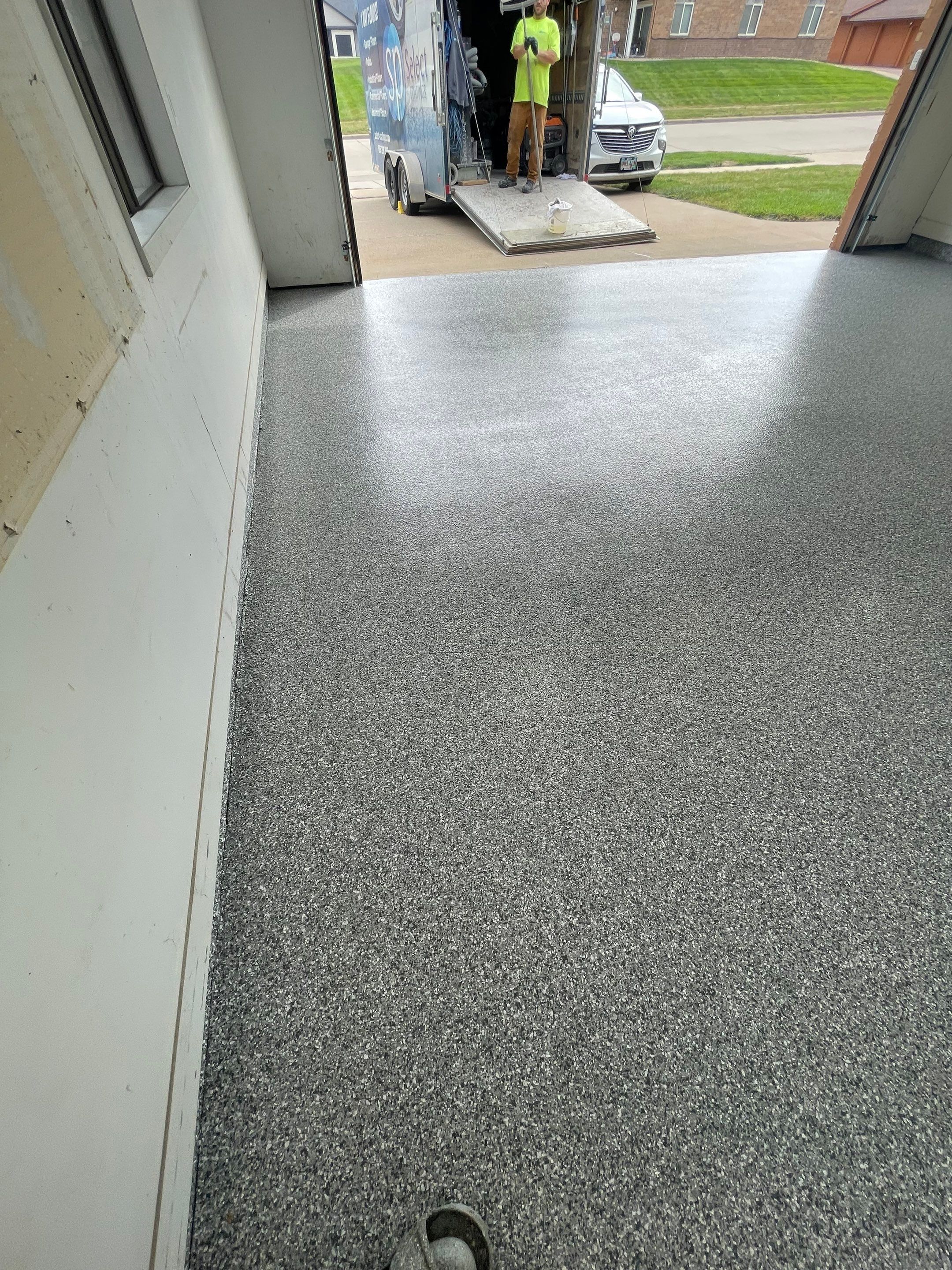 Grey Speckled Concrete Coating for Residential Garage in Yankton by Select Painting, Coatings & Garage Cabinets