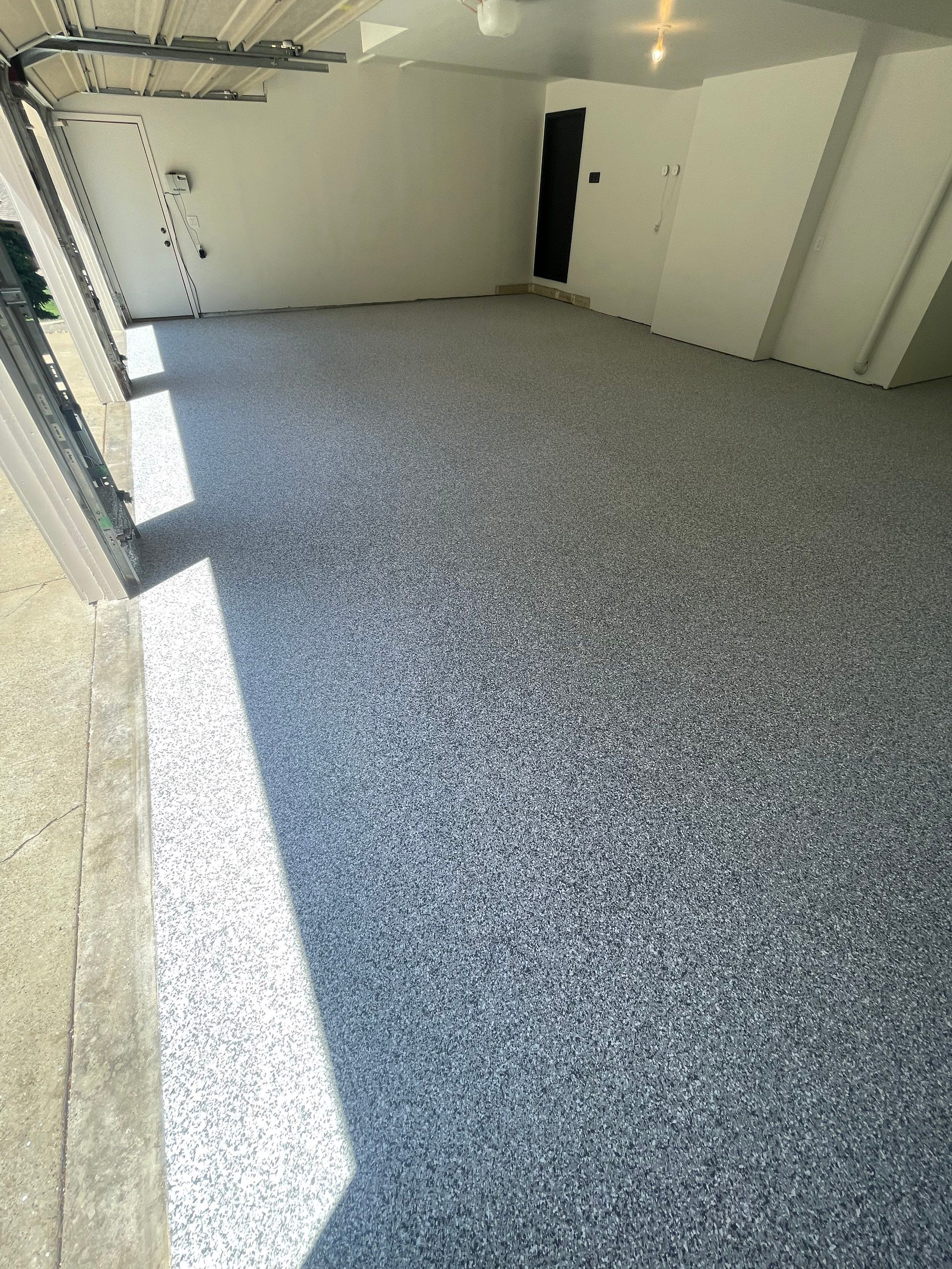 Gray Speckled Epoxy Garage Floor Coating in Sioux Falls by Select Painting, Coatings & Garage Cabinets