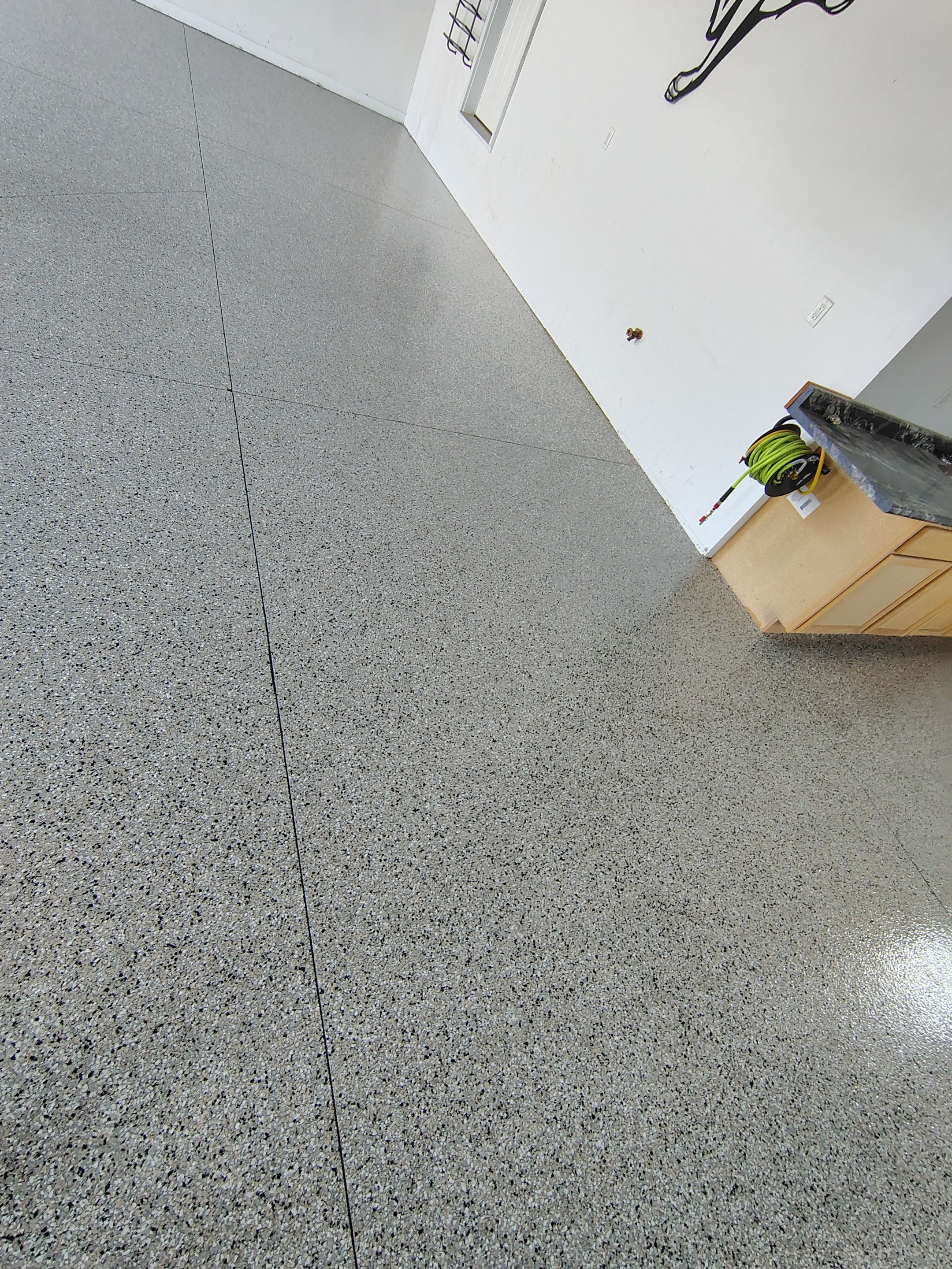 Speckled Polyaspartic Garage Floor Coating Installation in Dell Rapids by Select Painting, Coatings & Garage Cabinets