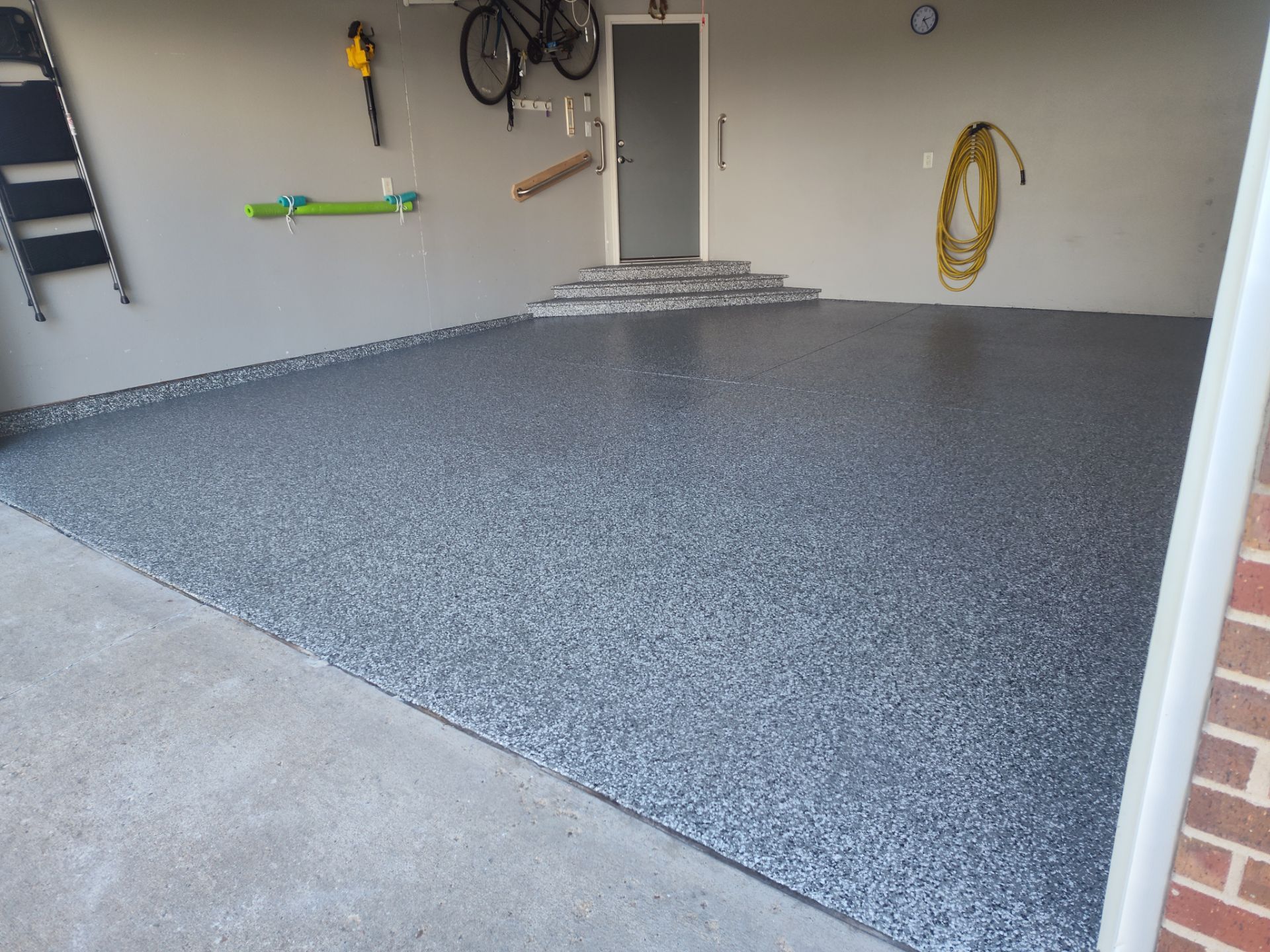 Close Up View of This Customer's New Flake Coating by Revival Concrete Coatings