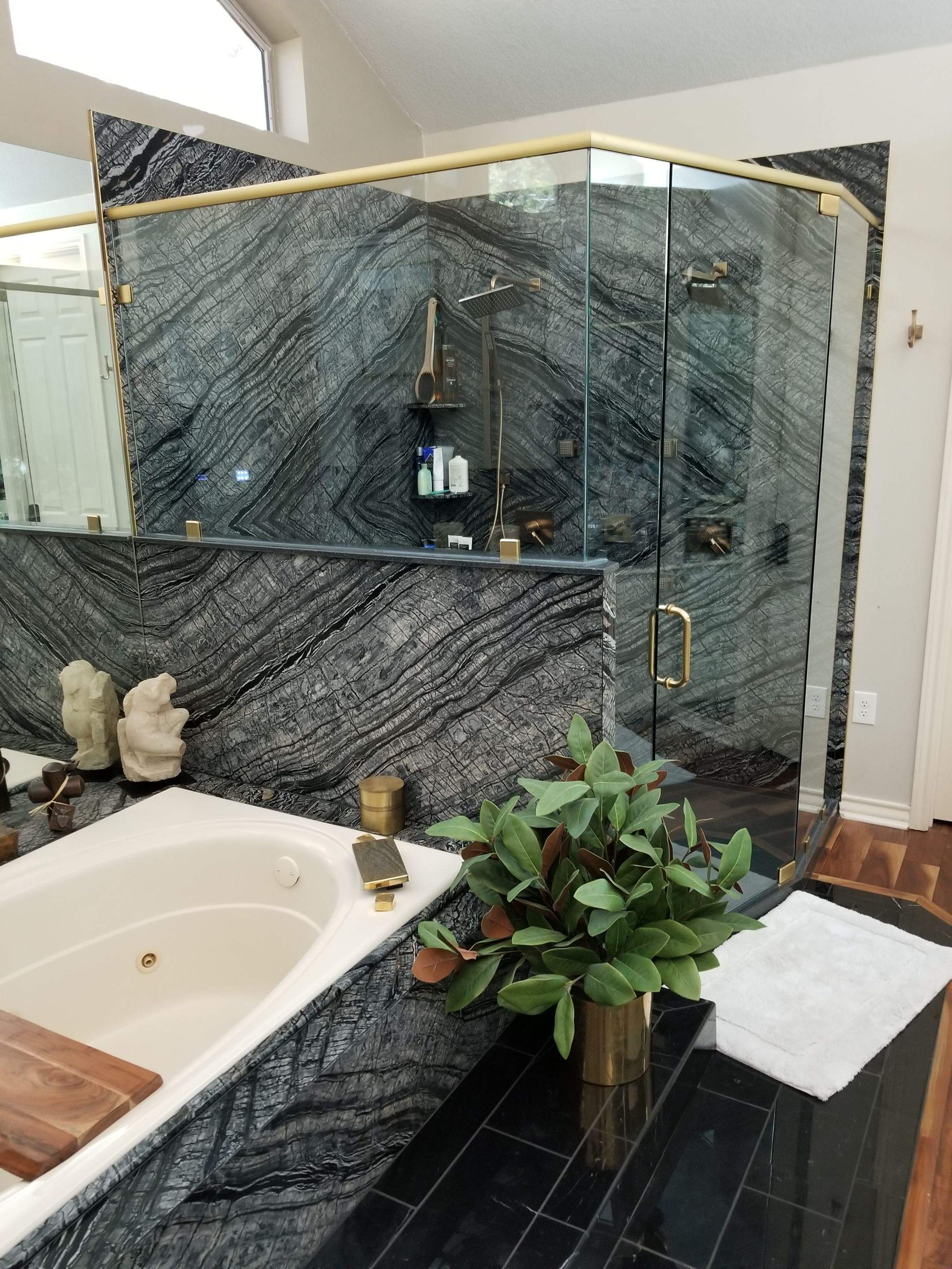 Bookmatched Natural Stone Shower by Legacy Bath and Kitchen 