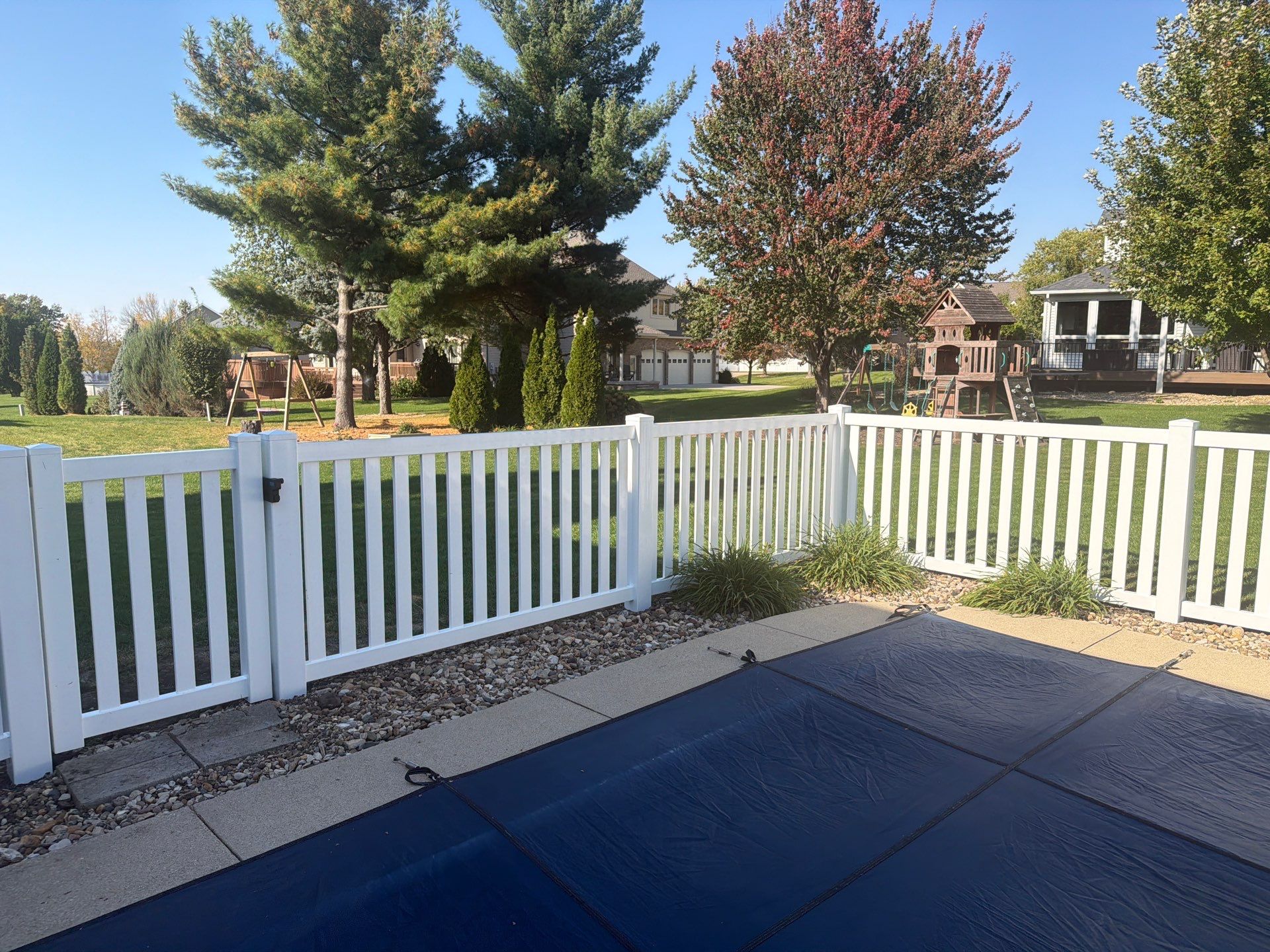 White Vinyl Picket Pool Fence Installation in Waterloo, Iowa by Perfect Picket Fence and Stain