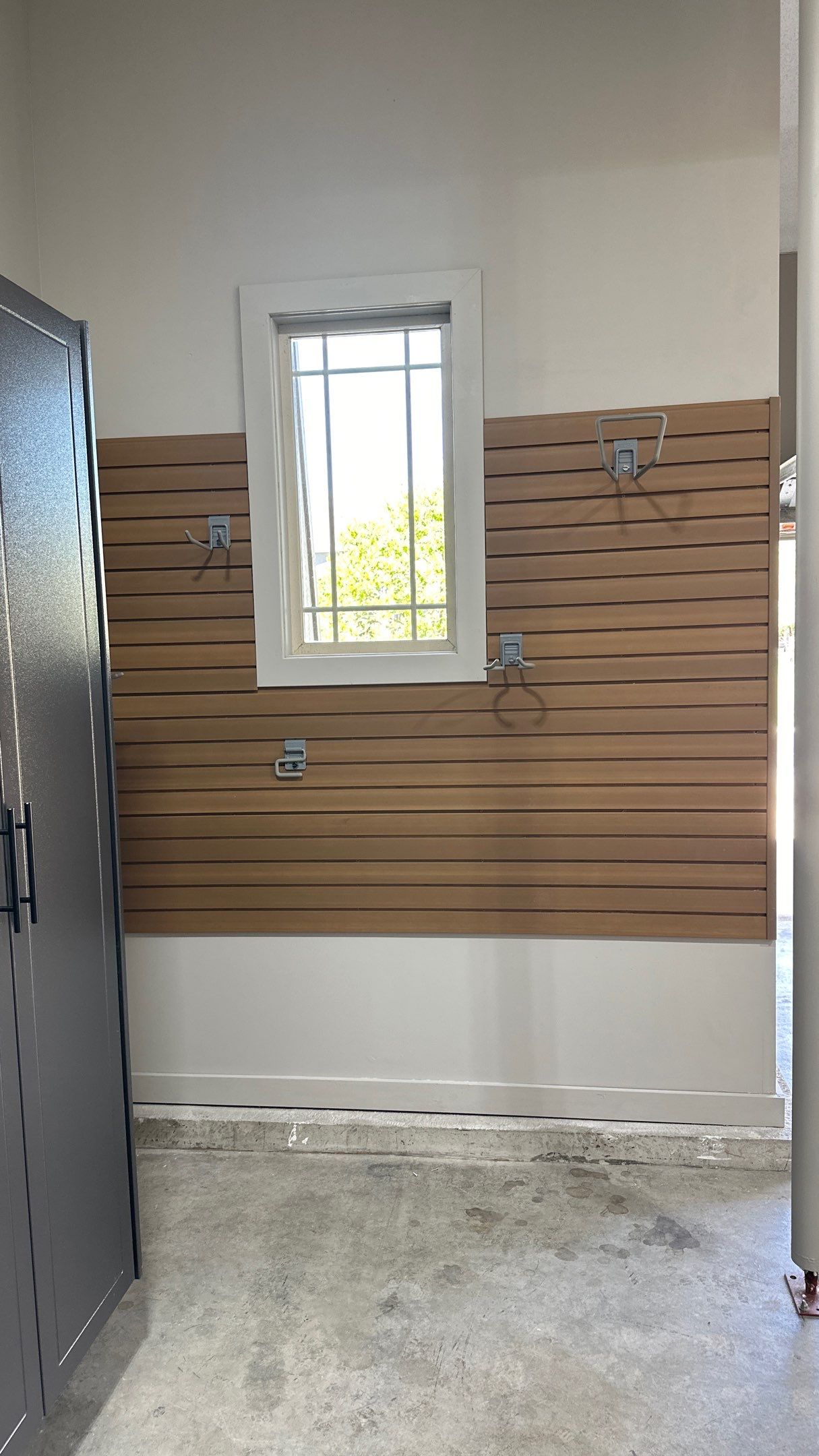 Mark S. chose Global Pine slotwall with his Pewter cabinets.  by Banner Garage