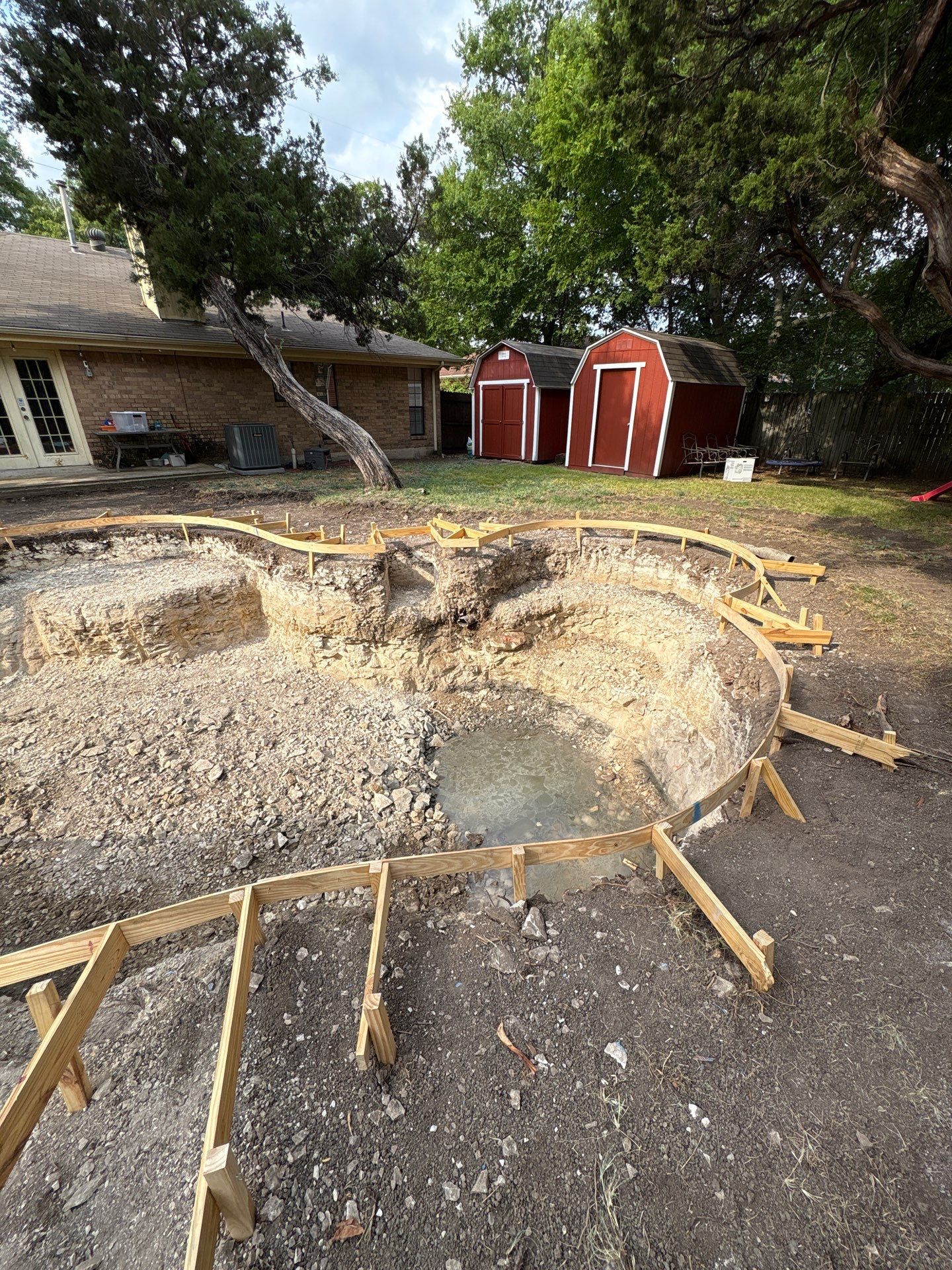Freeform Pool Remodel with New Decking and Pebble Interior by Pinnacle Pools and Spas - DFW