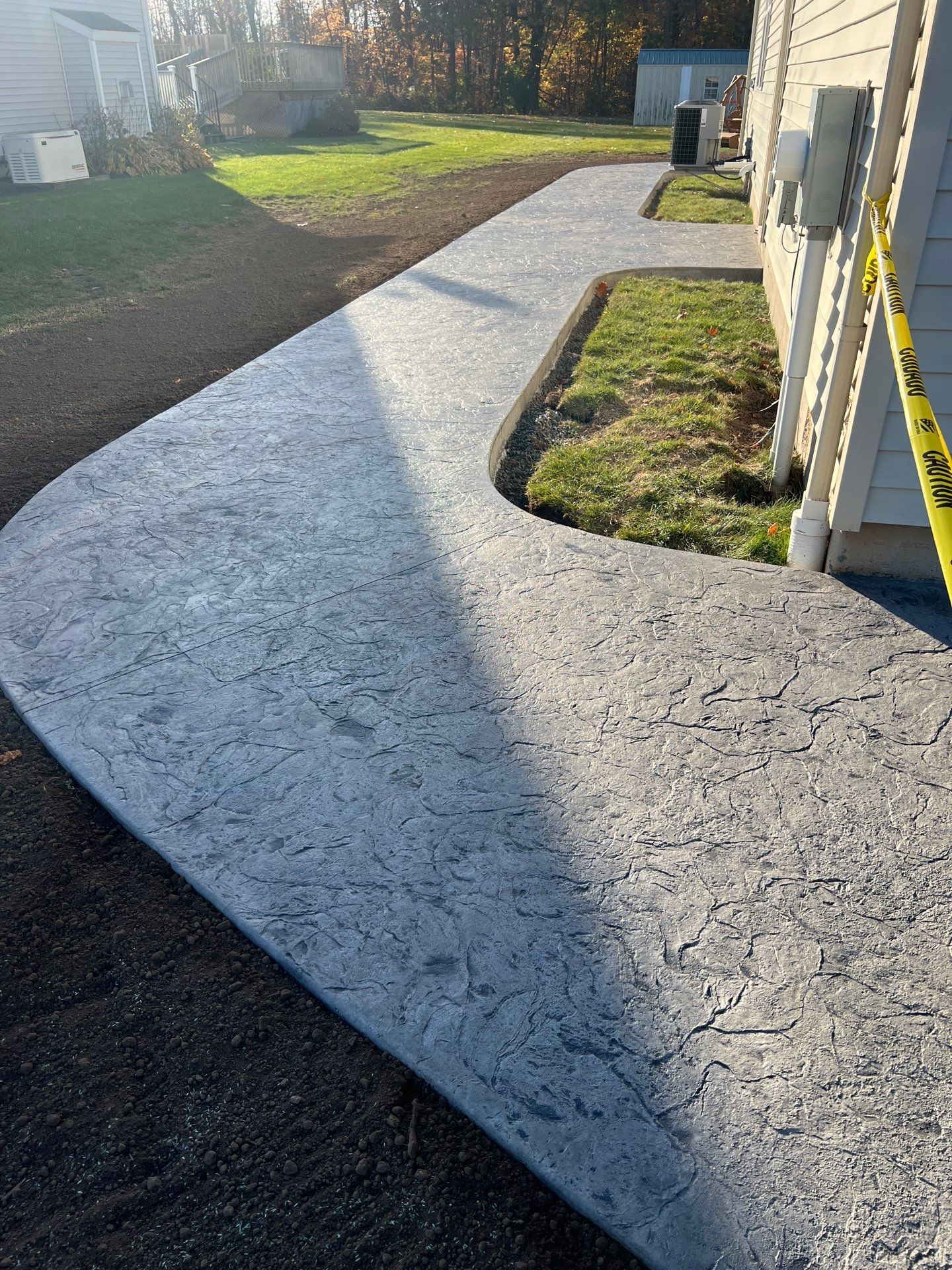 Oxford Slate stamped concrete patio  by NG Masonry & Construction LLC