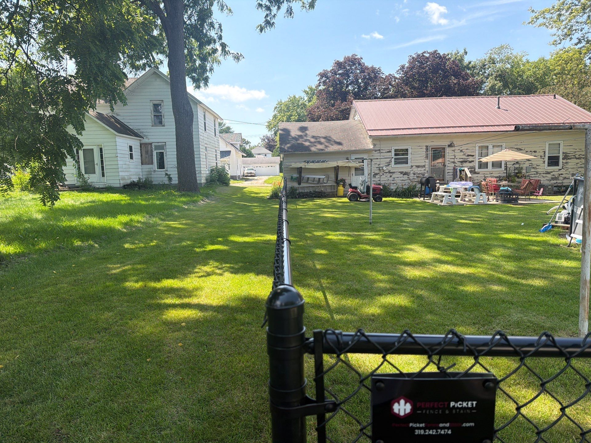 Black Chain Link Backyard Fence Installation in Tripoli, IA by Perfect Picket Fence and Stain