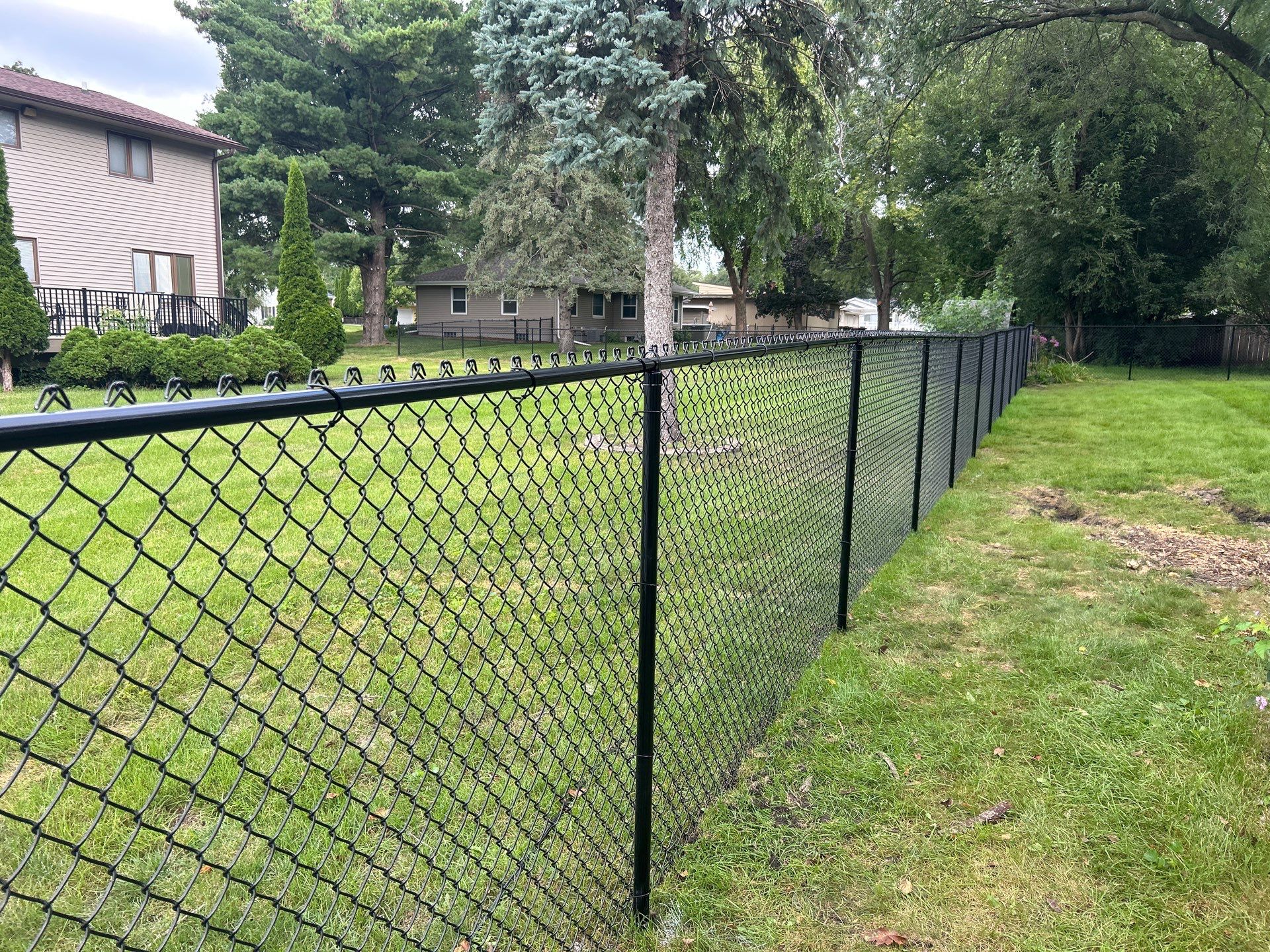 Black Vinyl Coated Chain Link Fence Installation in Waterloo by Perfect Picket Fence and Stain