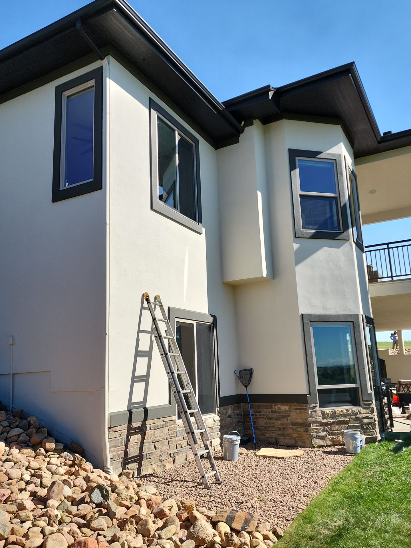 Castle Rock Elegance: White Stucco Exterior with Bold Tricorn Black by J&M Painting LLC