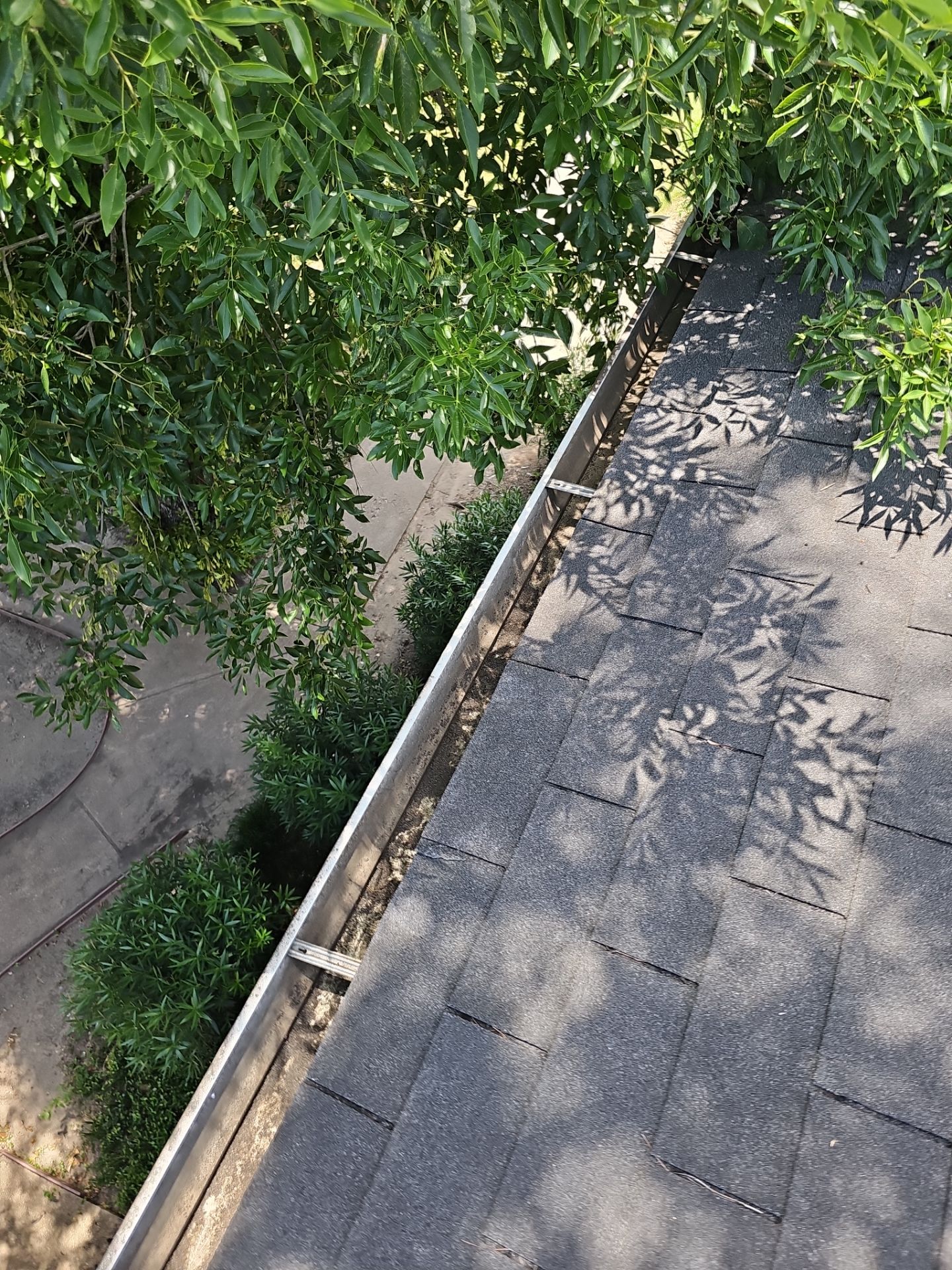 HOA gutter cleaning in League City & Webster, after  photo showing full gutters.