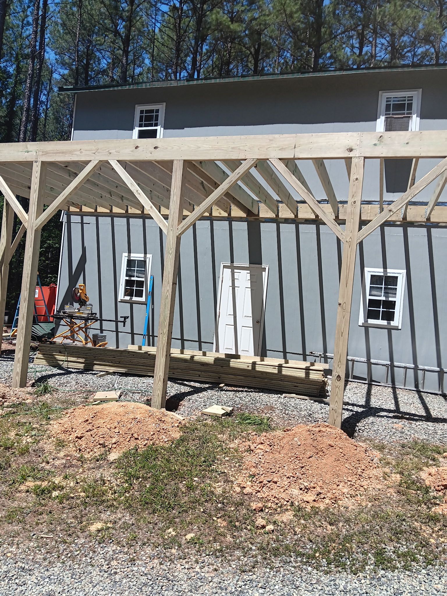 Pittsboro Outdoor Living Transformation – Retaining Wall, Paver Patio & Elevated Deck by Elite Remodeling and Design LLC