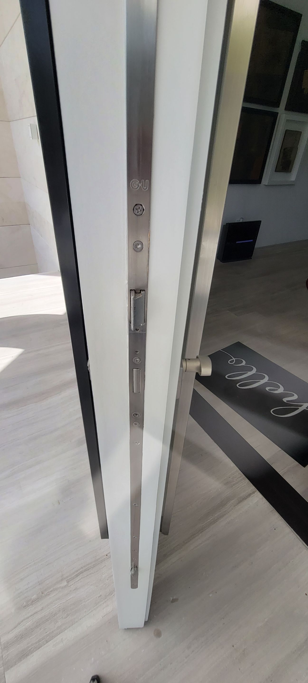 Custom Material Pivot Door installation by Impact Precious Wood Inc.