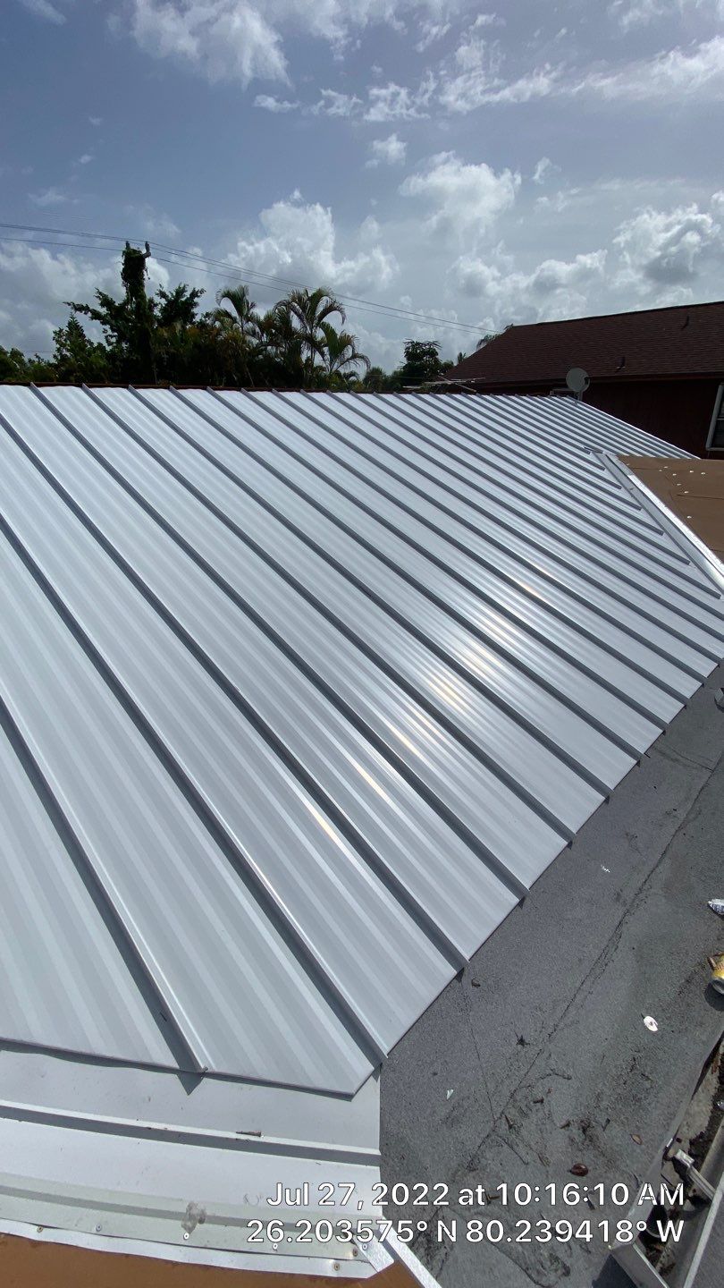 Residential Roofing Installation using 1.5" Nail Strip 24ga Solar White Kynar Coated Standing Seam Metal Panels by Morton Roofing, Inc.