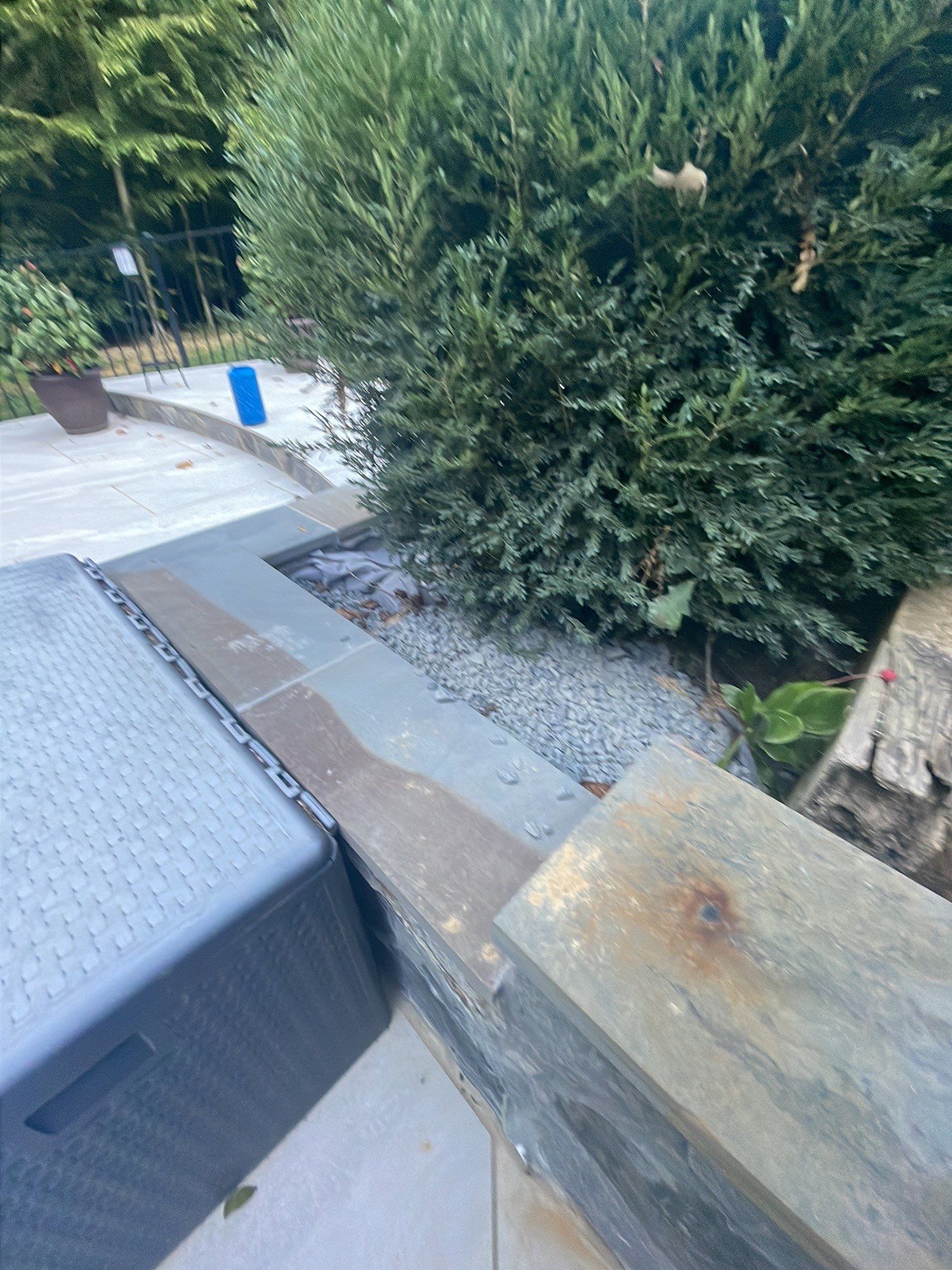 Pool Surround remodel with retaining walls, new waterfall and water slide by Fairfax Contractors, LLC