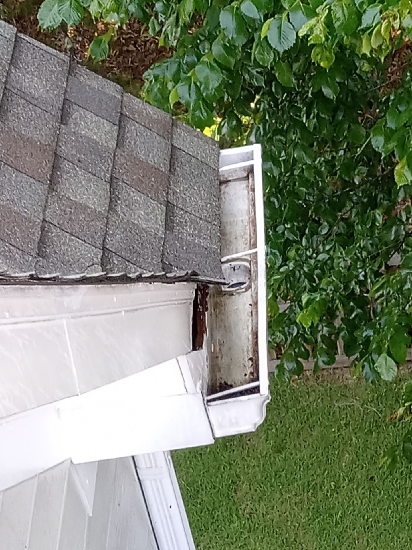 pressure washing gutter exterior to remove dirt and debris for clean and functional drainage