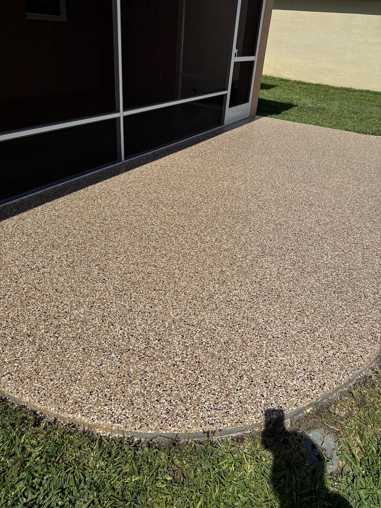 Garage and Lanai With Exterior Pad in Sandstone  by Innovative Concrete Coatings 
