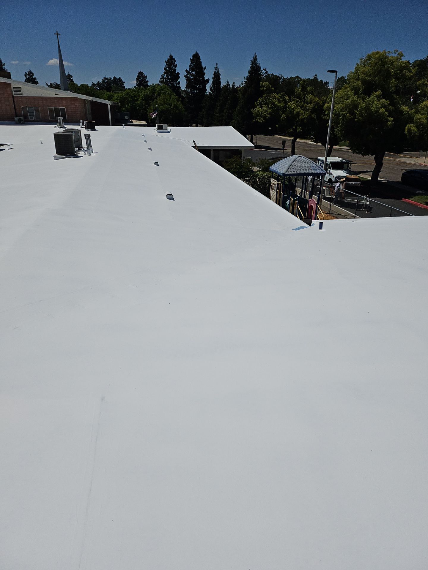 Single-ply restoration system using Benchmark/PUMA XL coatings over TPO single-ply roofing by Straight Edge Roofing Inc