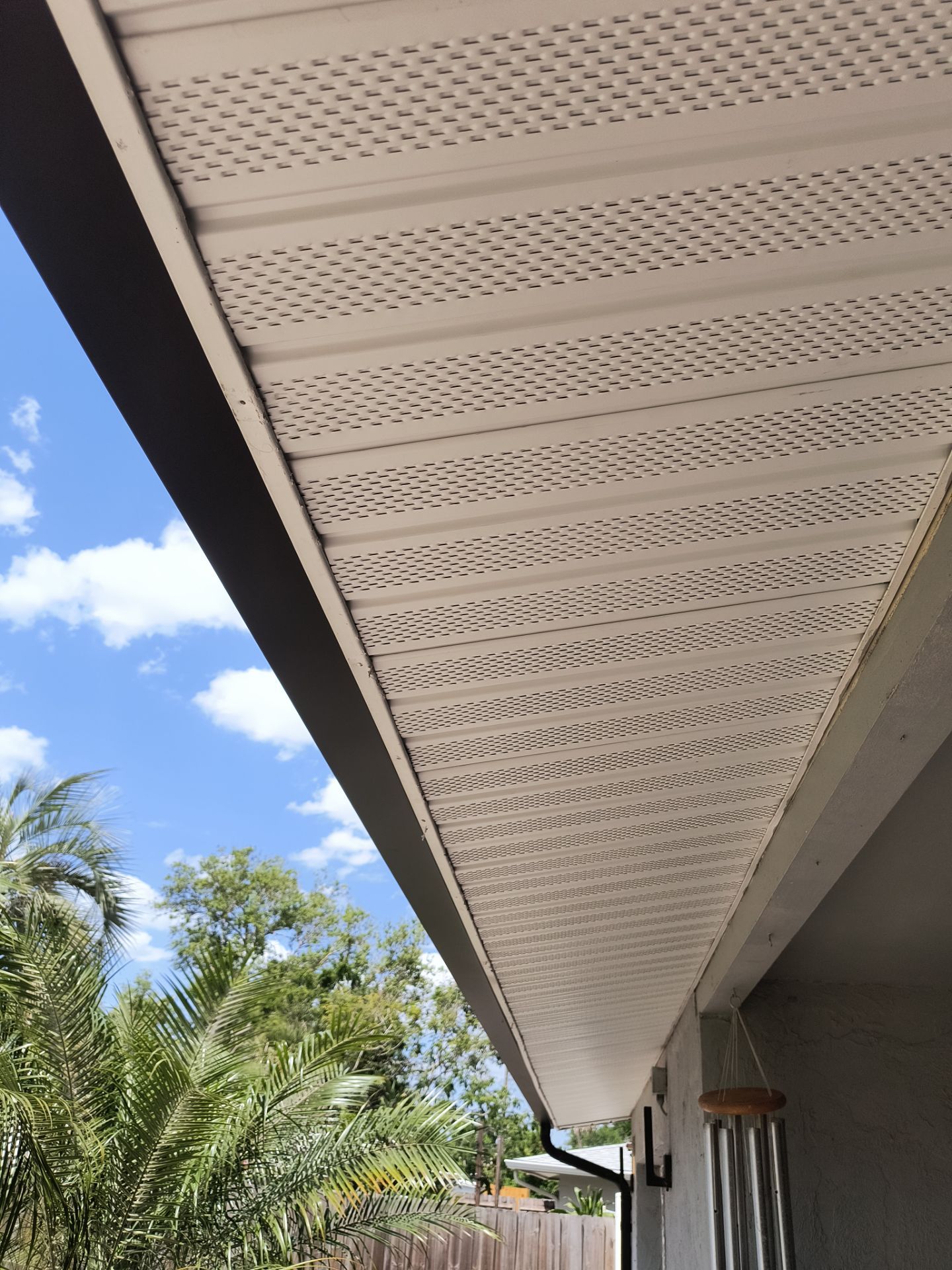 Black Seamless Gutters using 7 inch seamless gutters & New White Soffit in Sarasota FL by Gutter Professors