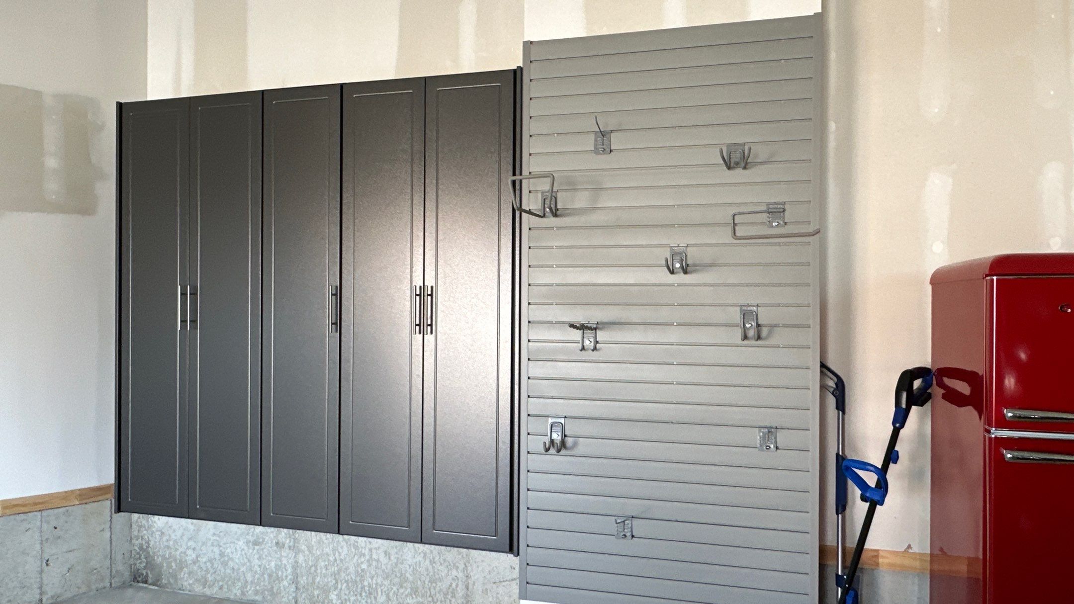 Megan J. added cabinets and slotwall to her garage. Plus a New Floor by Banner Garage