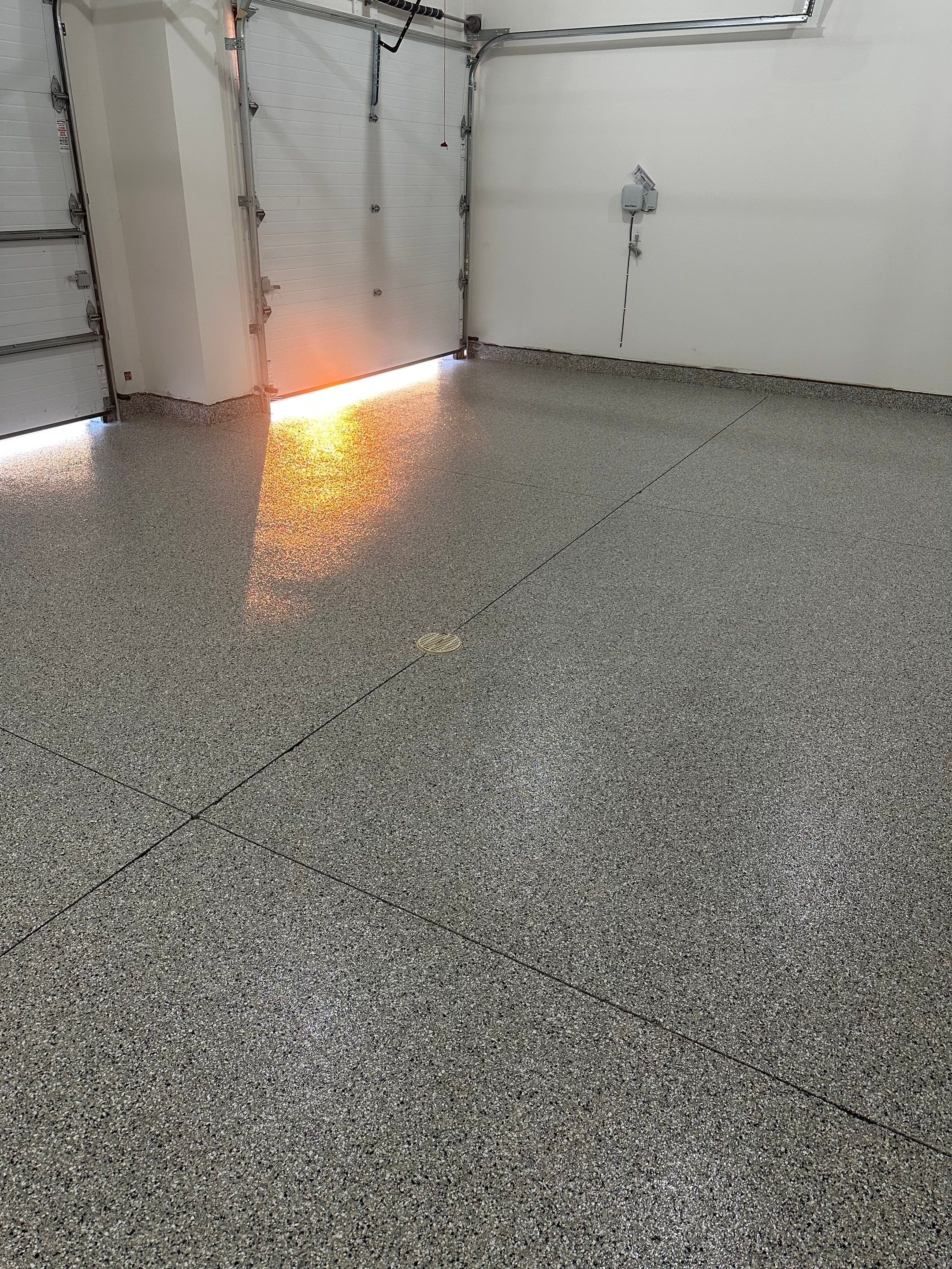 Cabin Fever Decorative Flake Garage Floor Coating in Sioux Falls by Select Painting, Coatings & Garage Cabinets