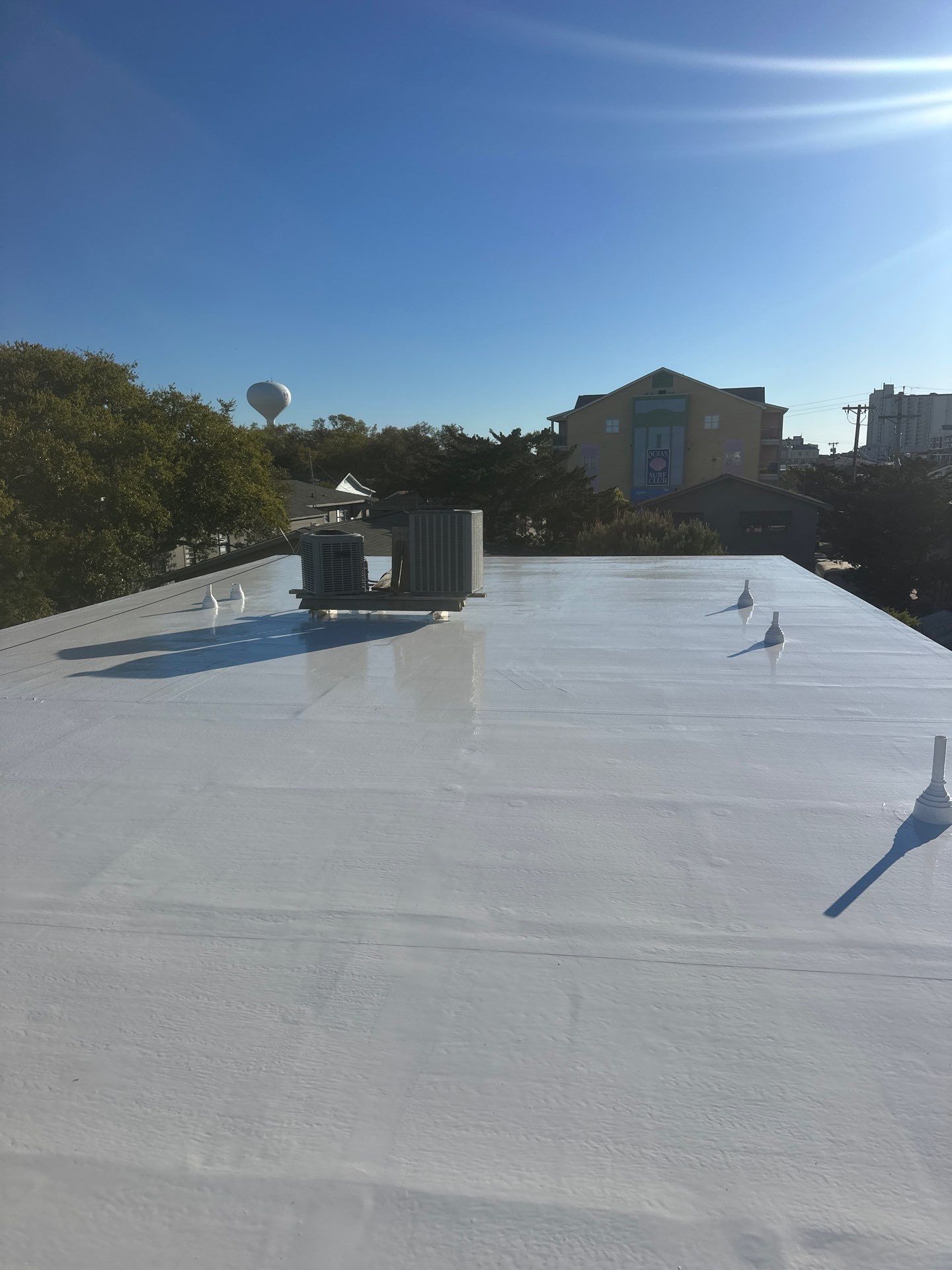 Commercial Building Roof Coating using 924 Eterna-Sil Premium Silicone Roof Coating by RGR Construction and Roofing, LLC