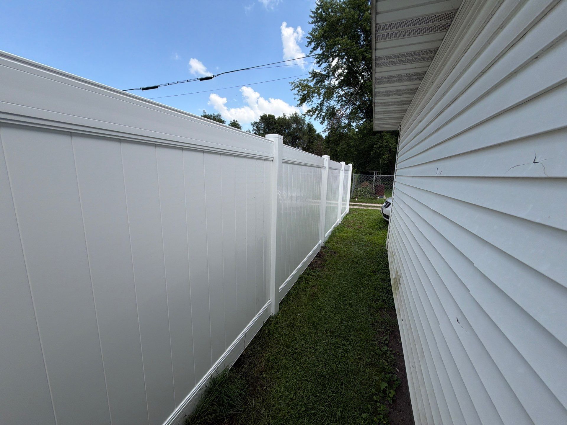 White Vinyl Privacy Fence Installation in Waterloo, Iowa by Perfect Picket Fence and Stain
