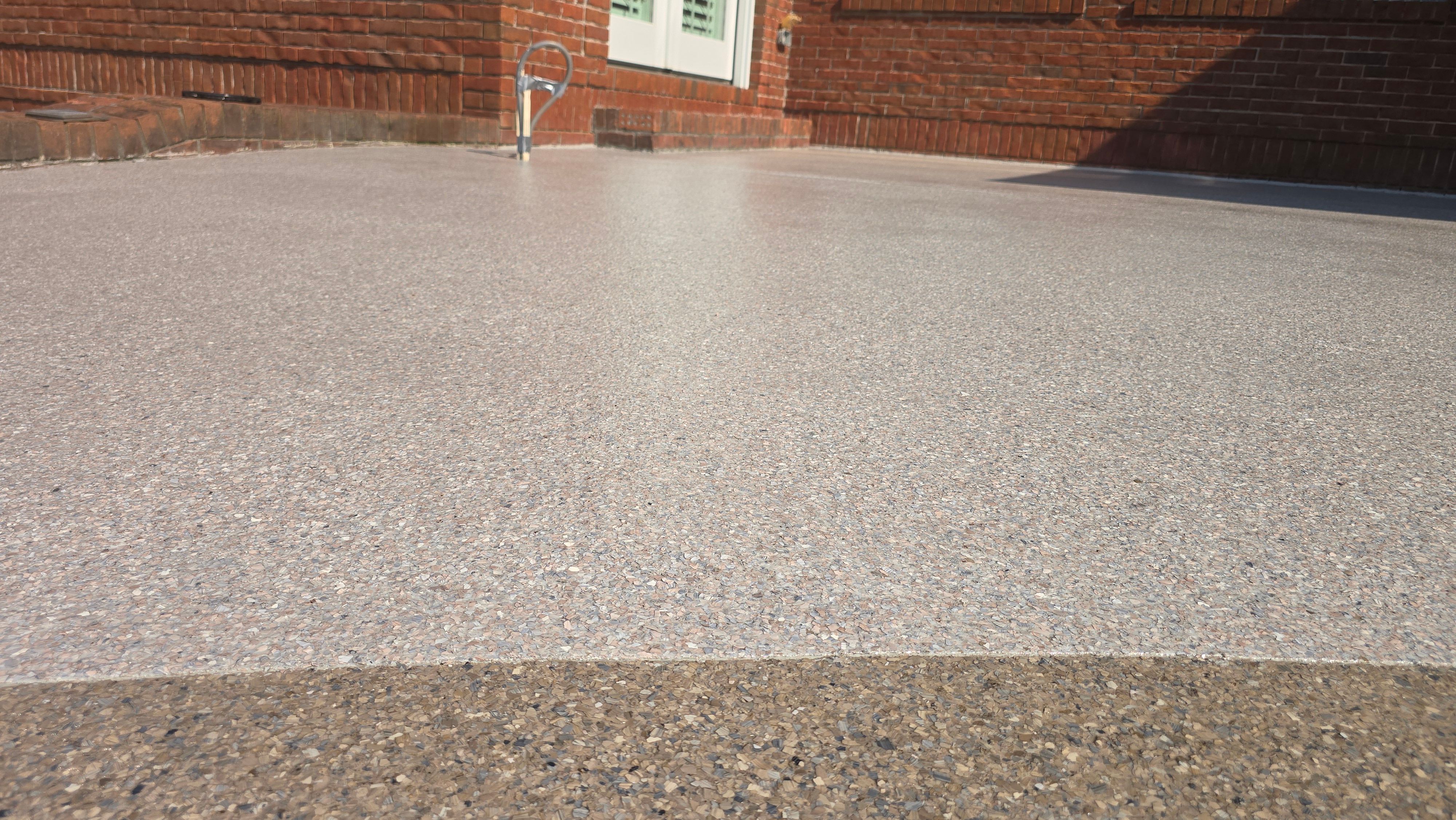 Patio in Pumice with Obsidian Border  by Elite Floor Solutions