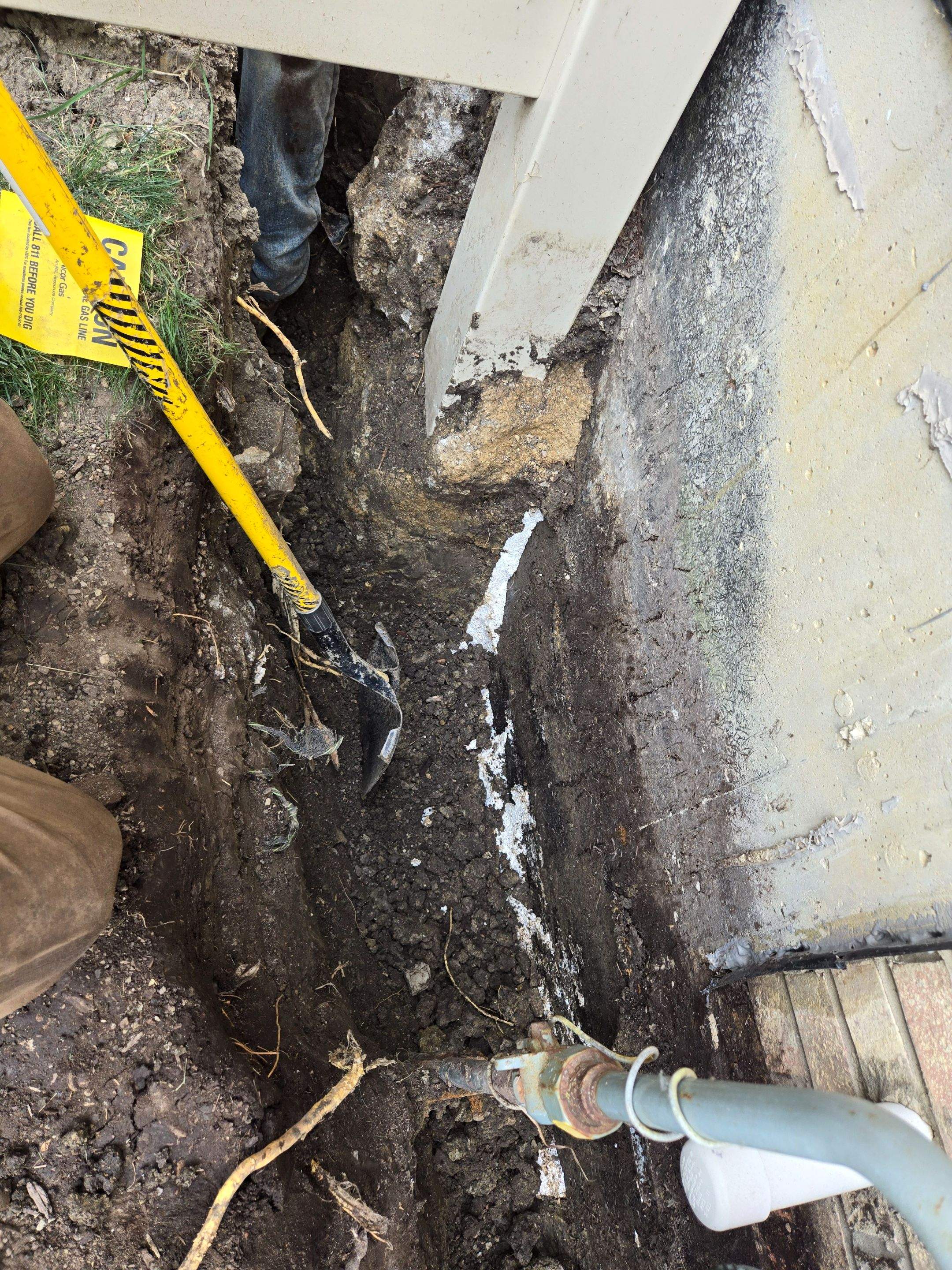 Burial of Sump Pump and Down Spout Discharges and Partial Waterproofing of Wall by Allied Water Services