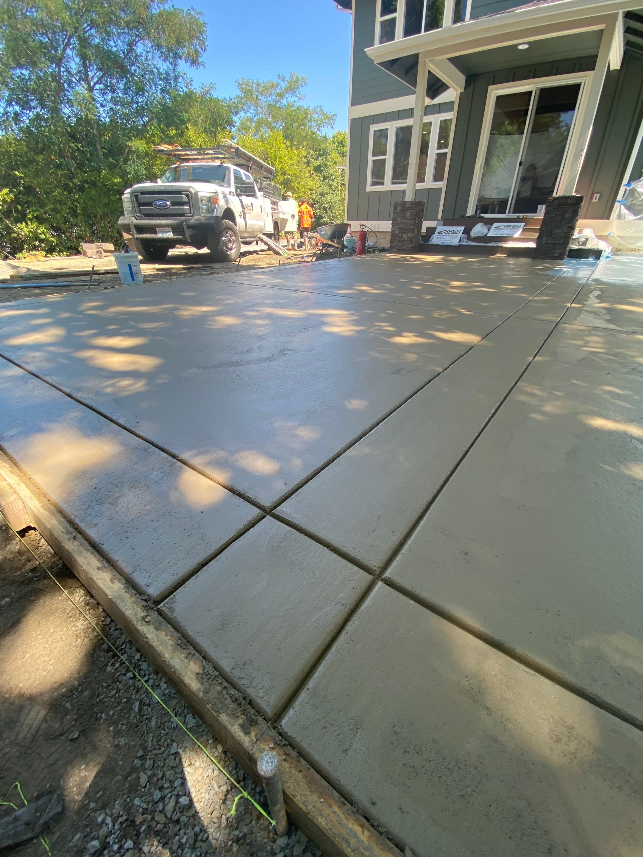 Patio Installation using Concrete, Retaining walls, and Turf install by Jireh Asphalt & Concrete Inc 