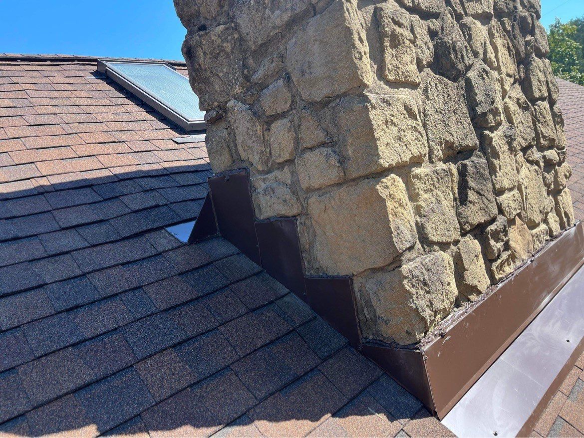 Shingle Roofing with Velux Skylight replacement and stone chimney flashing  by Secure Construction Company Inc