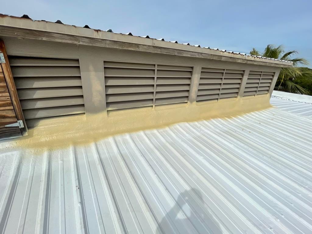 Metal roof restoration on commercial roof using Conklin Benchmark/ PUMA XL acrylic coatings over metal and foam by Straight Edge Roofing Inc