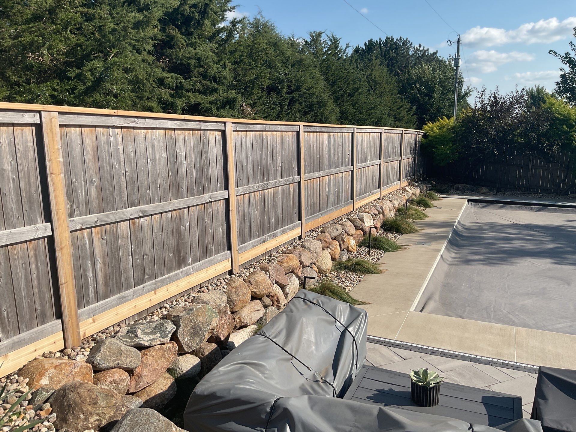Custom Privacy Fence and Paver Patio Installation in Sioux Falls by Select Painting, Coatings & Garage Cabinets