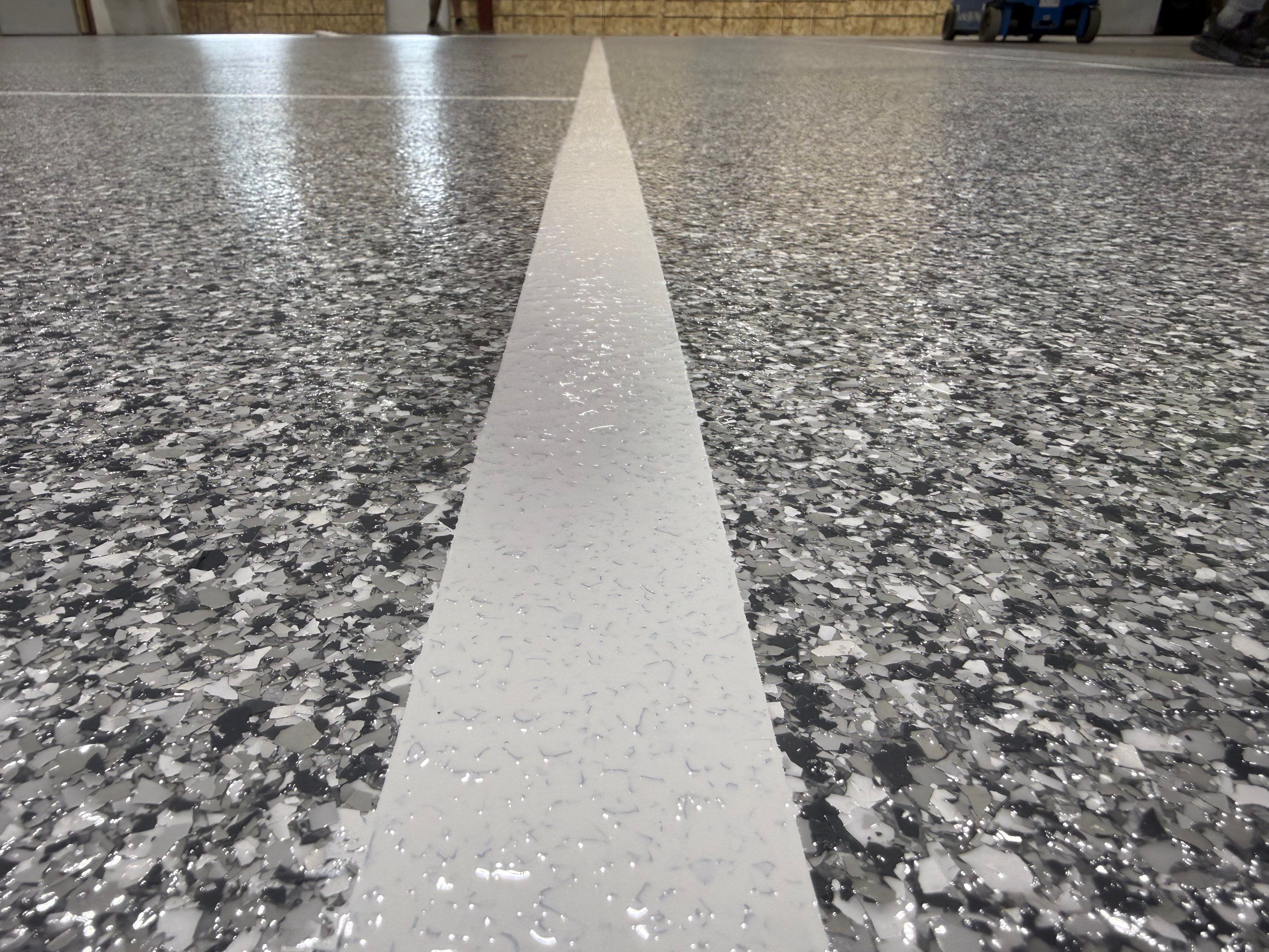 Custom Polyurea Shop Floor with Basketball Court Lines in Rock Valley by Select Painting, Coatings & Garage Cabinets