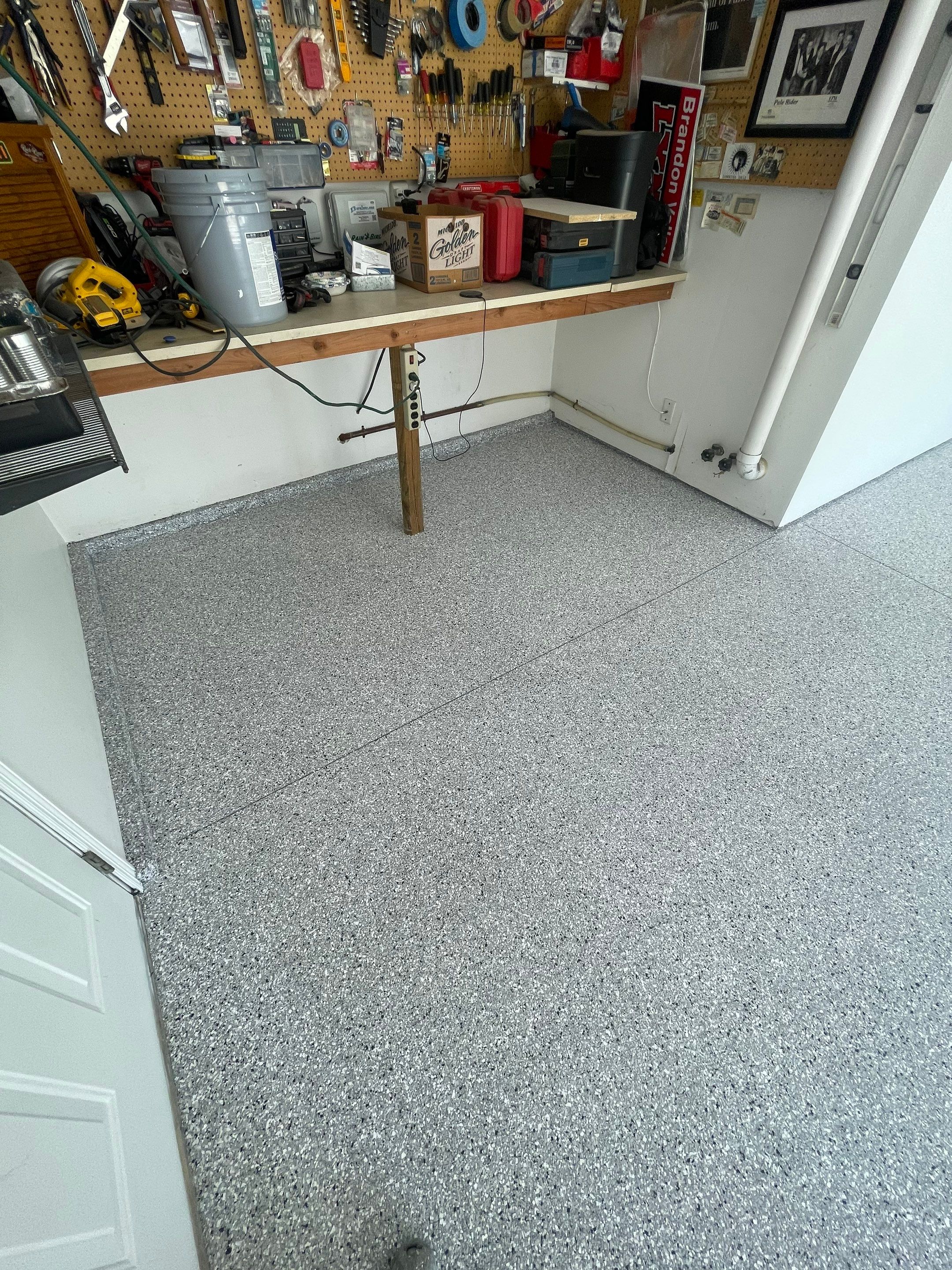 Feather Grey Garage Floor Coating Installation in Sioux Falls by Select Painting, Coatings & Garage Cabinets