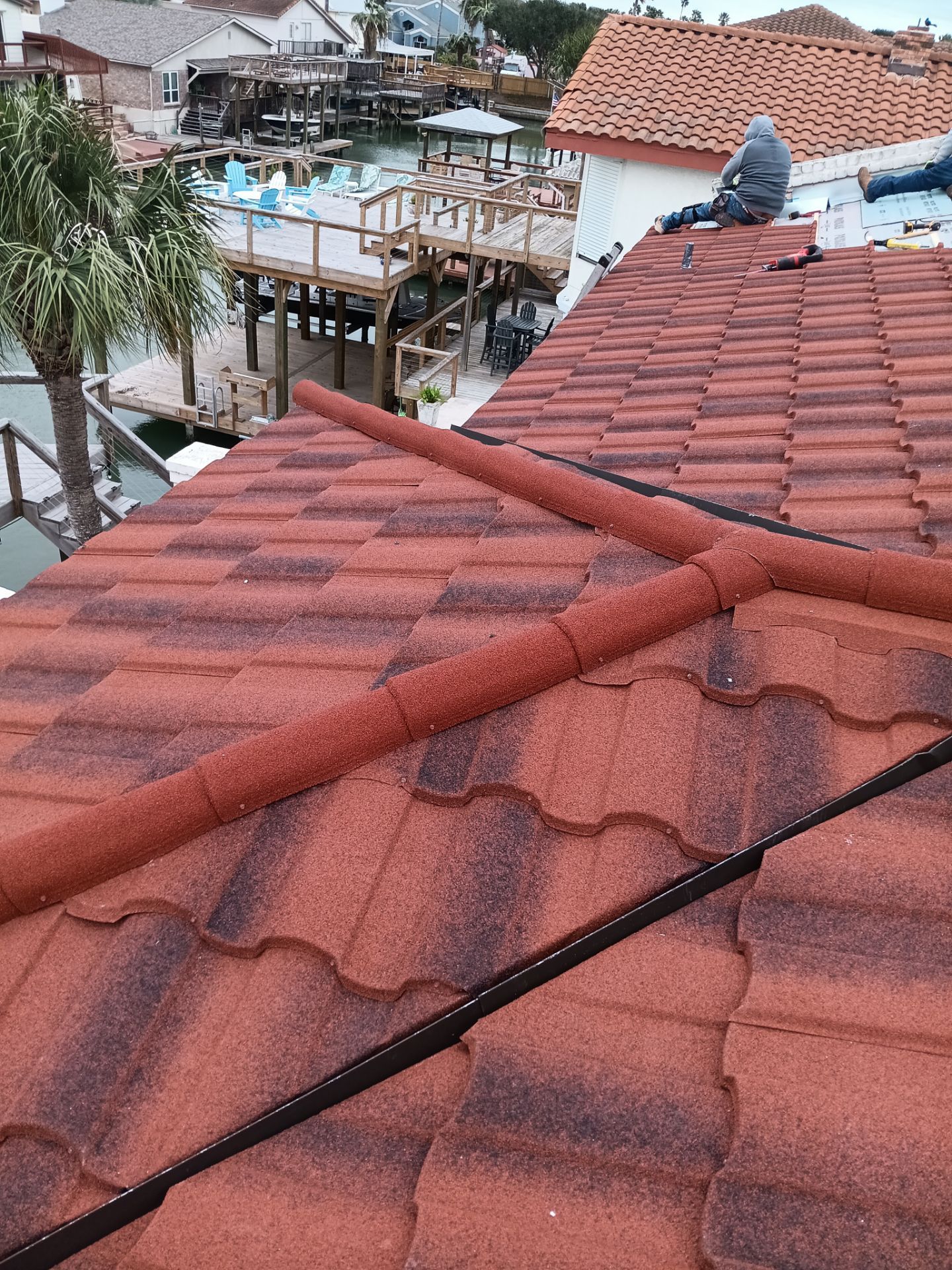 Off with the Tile and on with the TILCOR stone coated metal.  by Bayfront Roofing and Construction