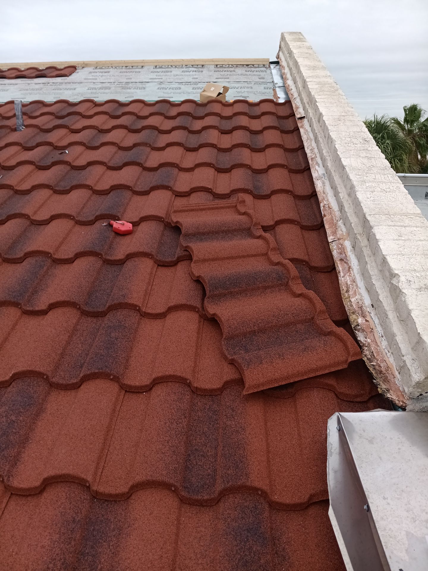 Off with the Tile and on with the TILCOR stone coated metal.  by Bayfront Roofing and Construction