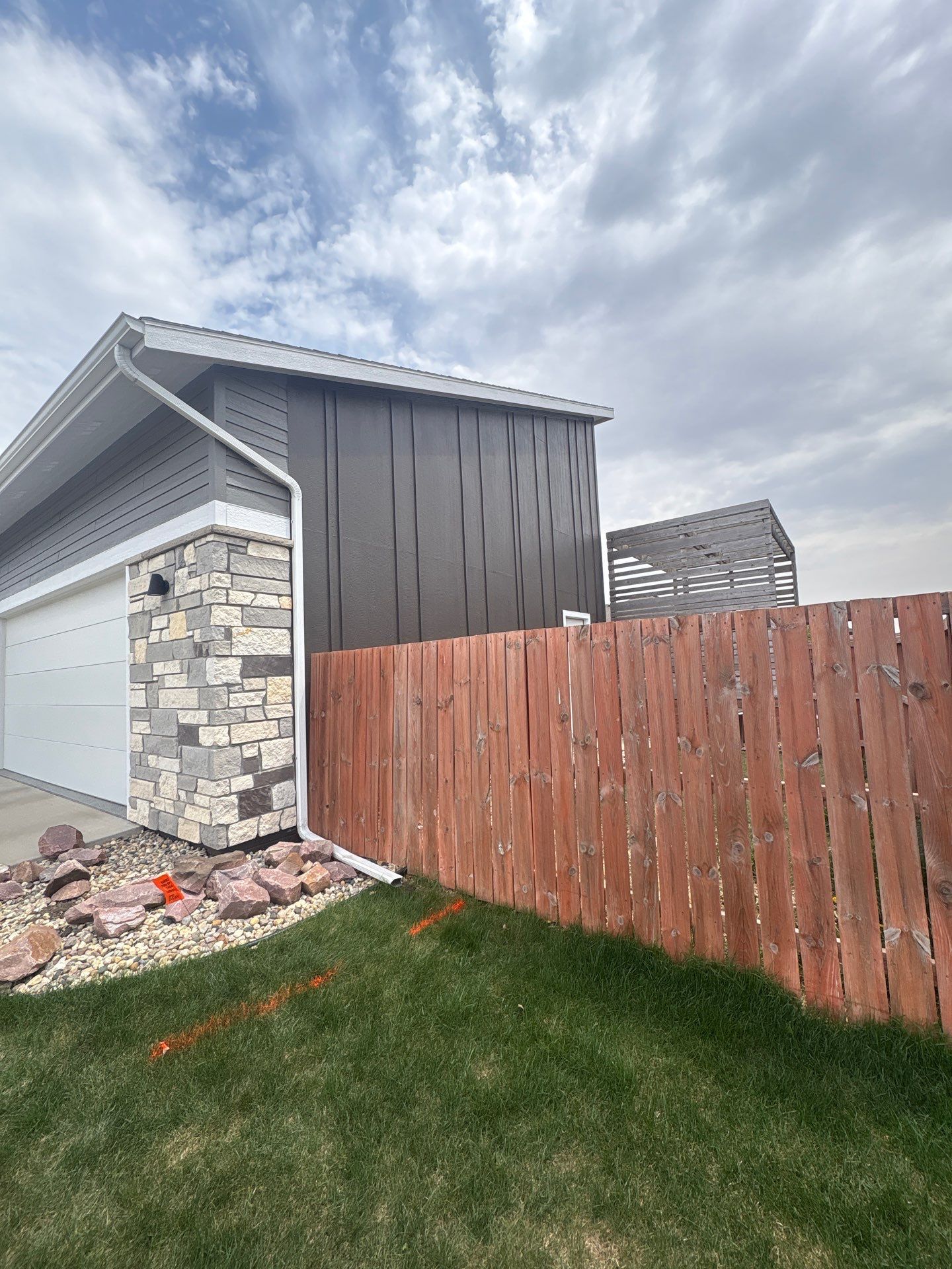 Modern Exterior Transformation Featuring Dark Board and Batten Siding in Sioux Falls by Select Painting, Coatings & Garage Cabinets