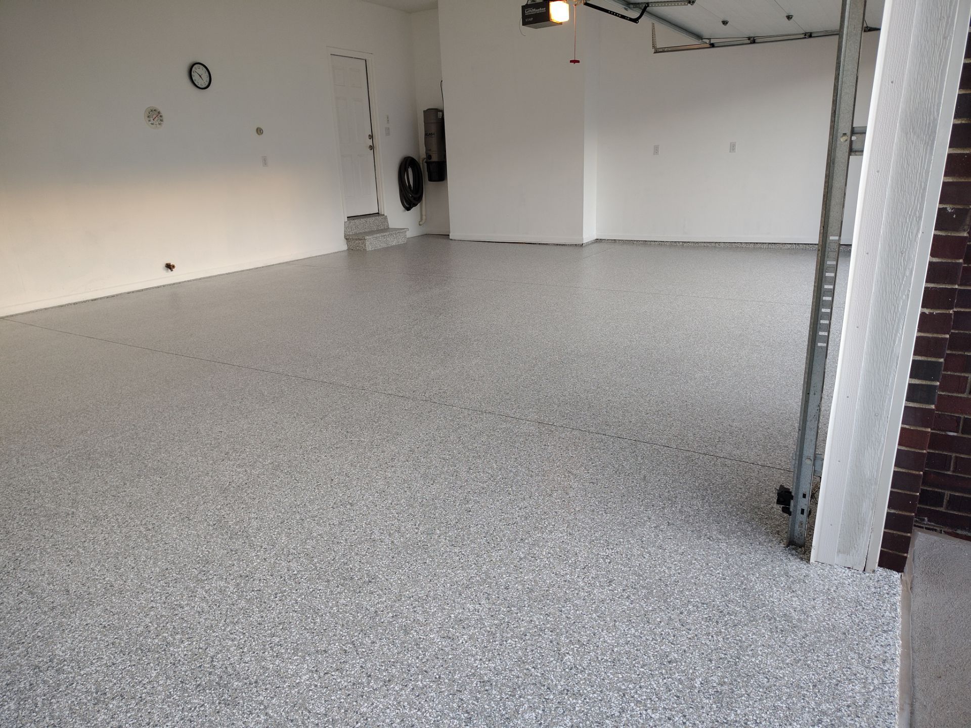 New Johnston Garage Resurfacing by Revival Concrete Coatings, LLC