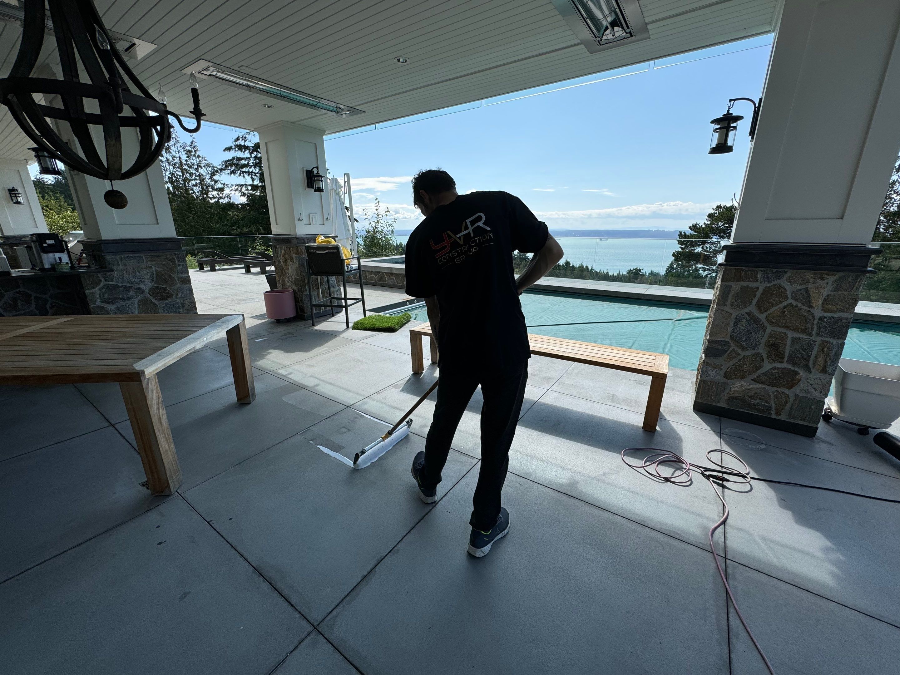Applying Concrete Sealer  by YVR Construction Group